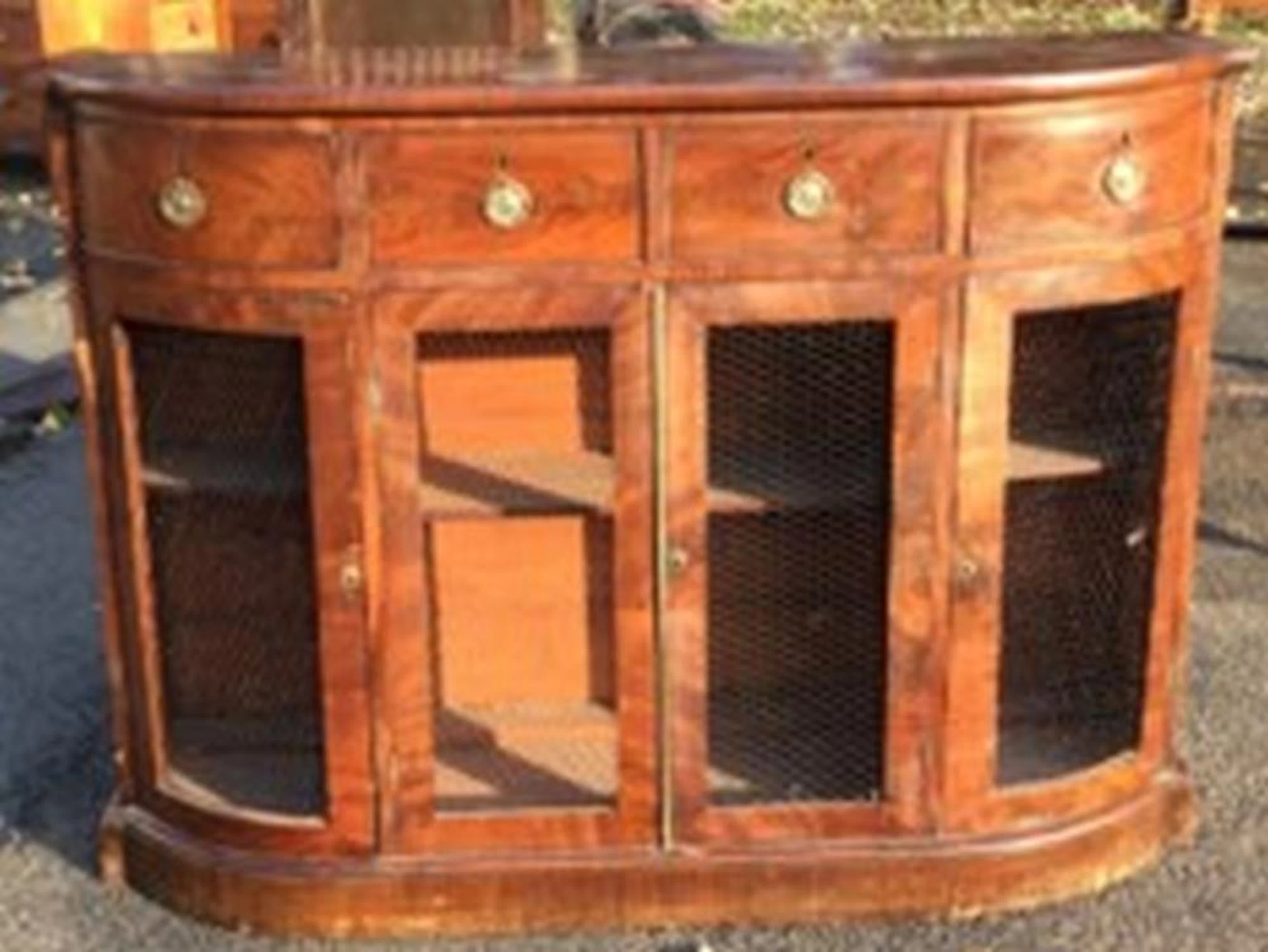 A bowfronted Victorian mahogany side cabinet with four cockbeaded frieze dr