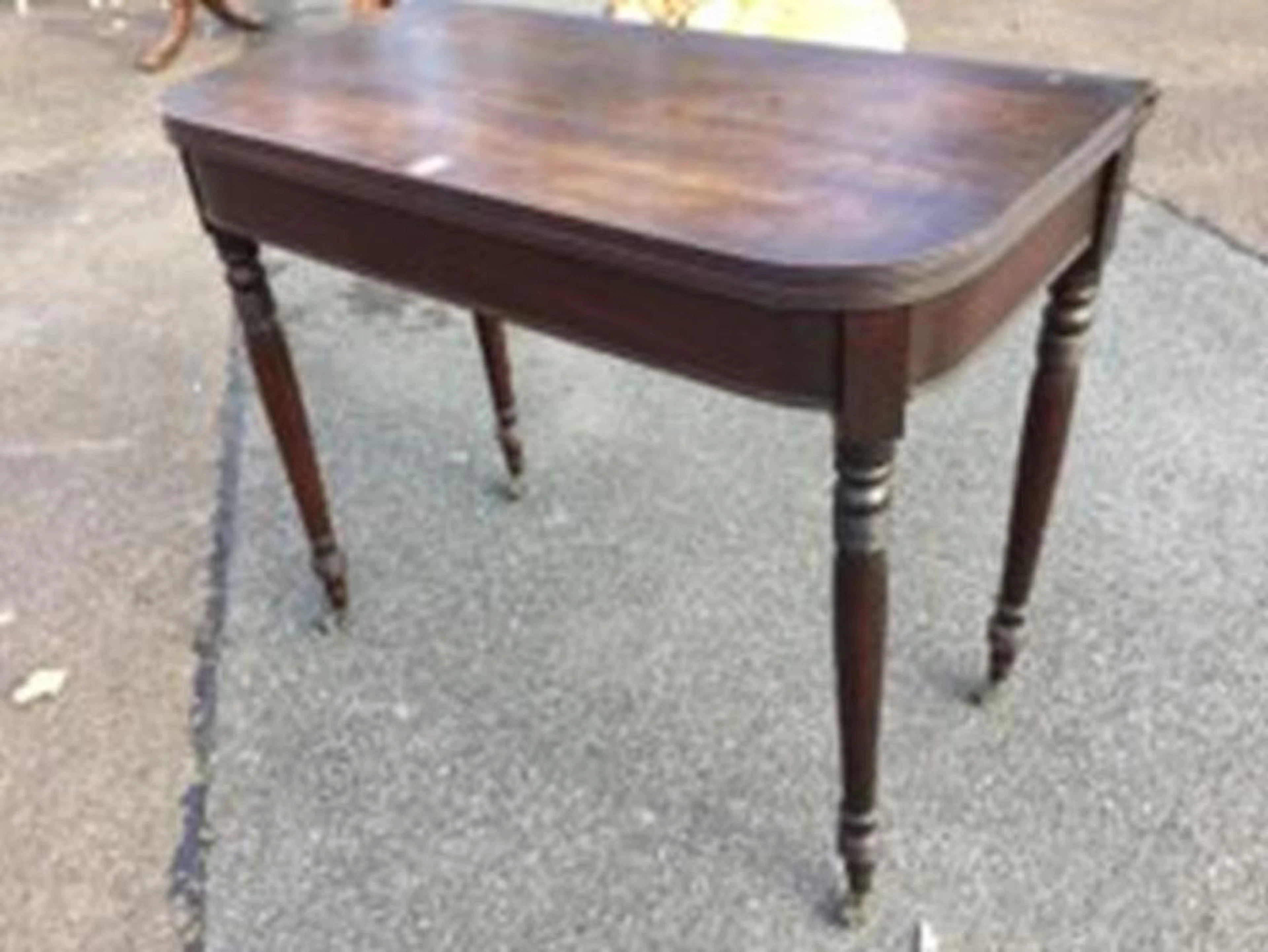 A nineteenth century mahogany turn-over-top tea table with rounded reeded