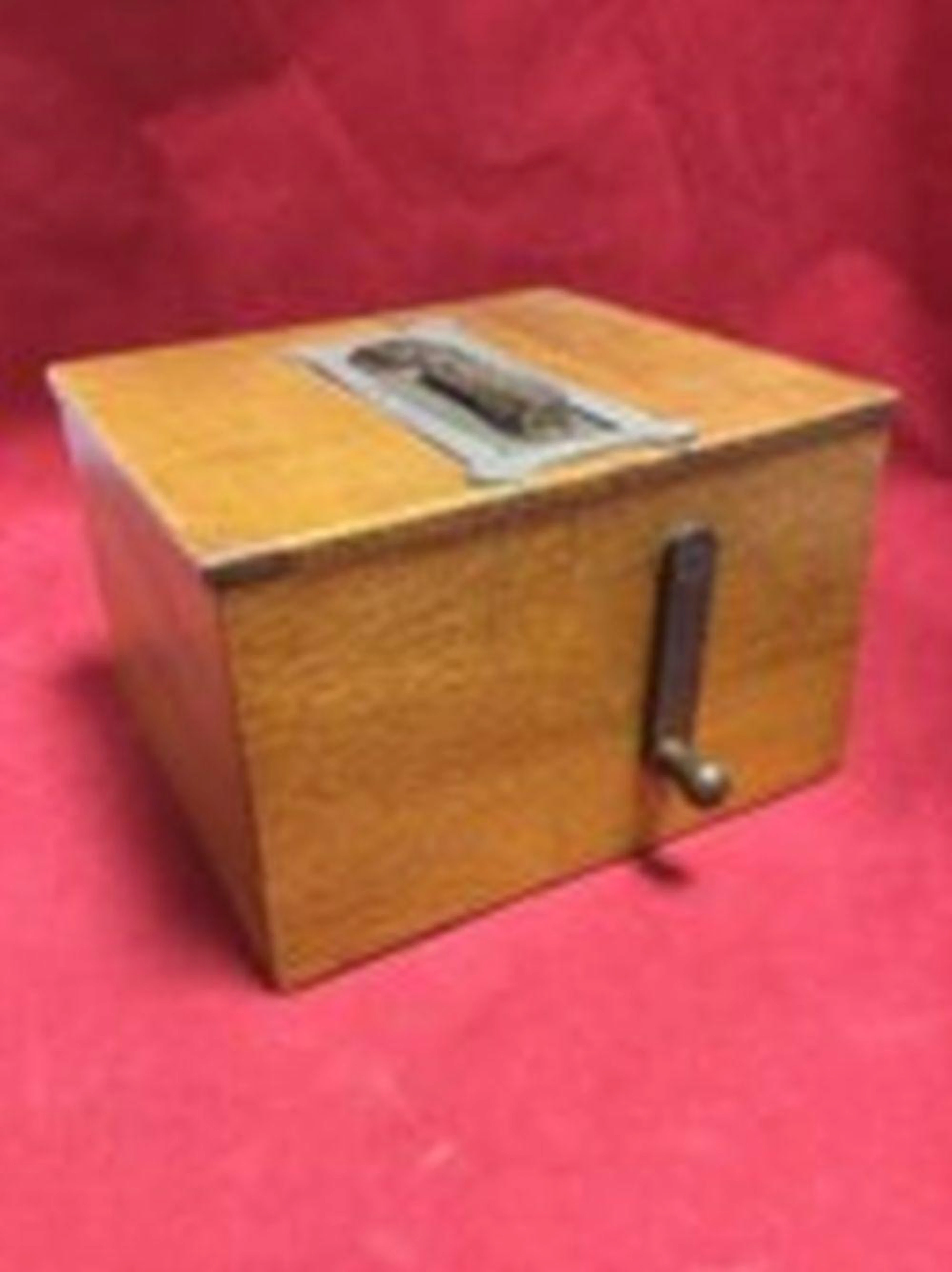 An unusual oak cased musical box, the brass crank handle driving bellows,