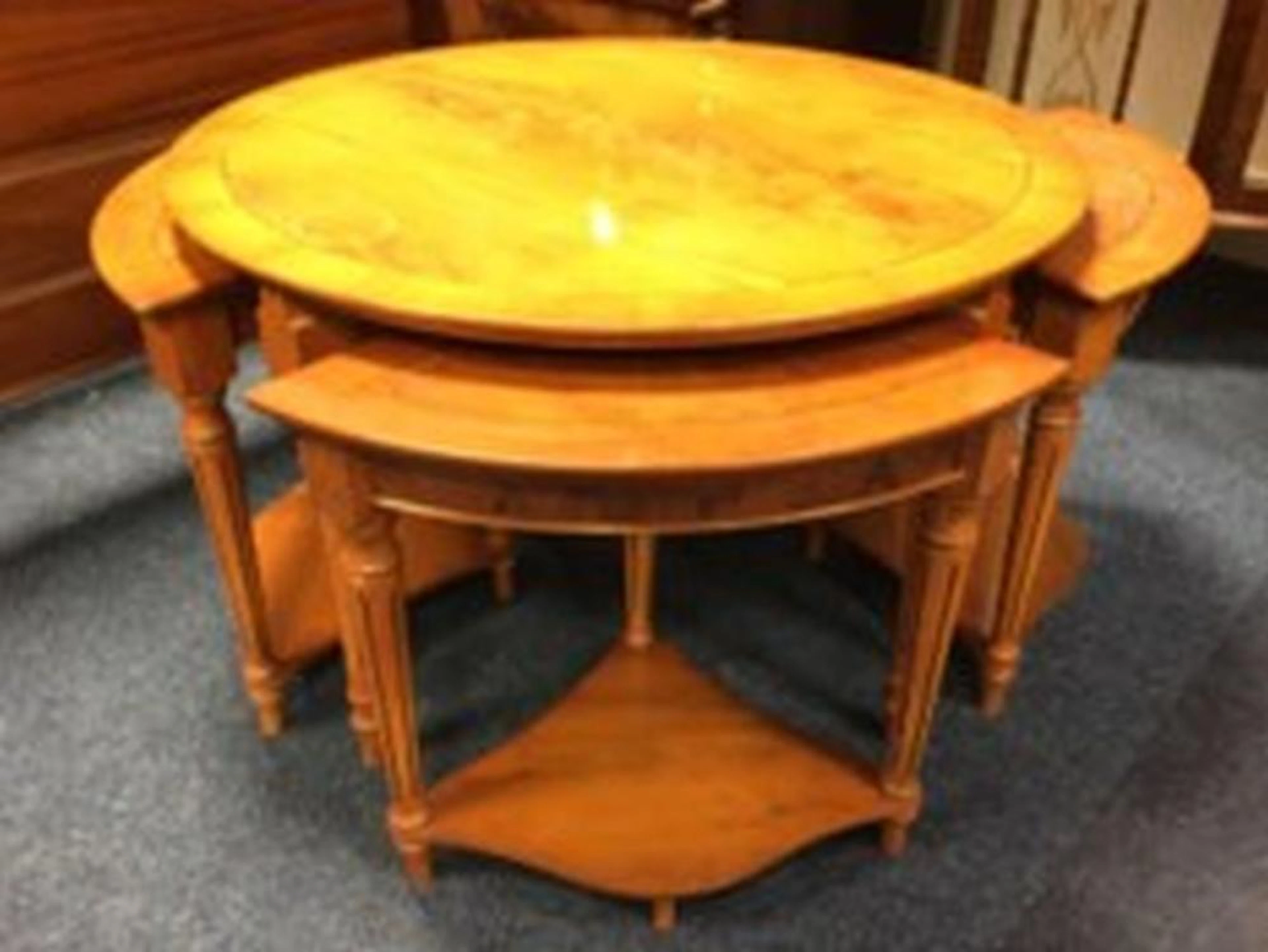 A circular yew coffee table, the crossbanded top supported on fluted turned