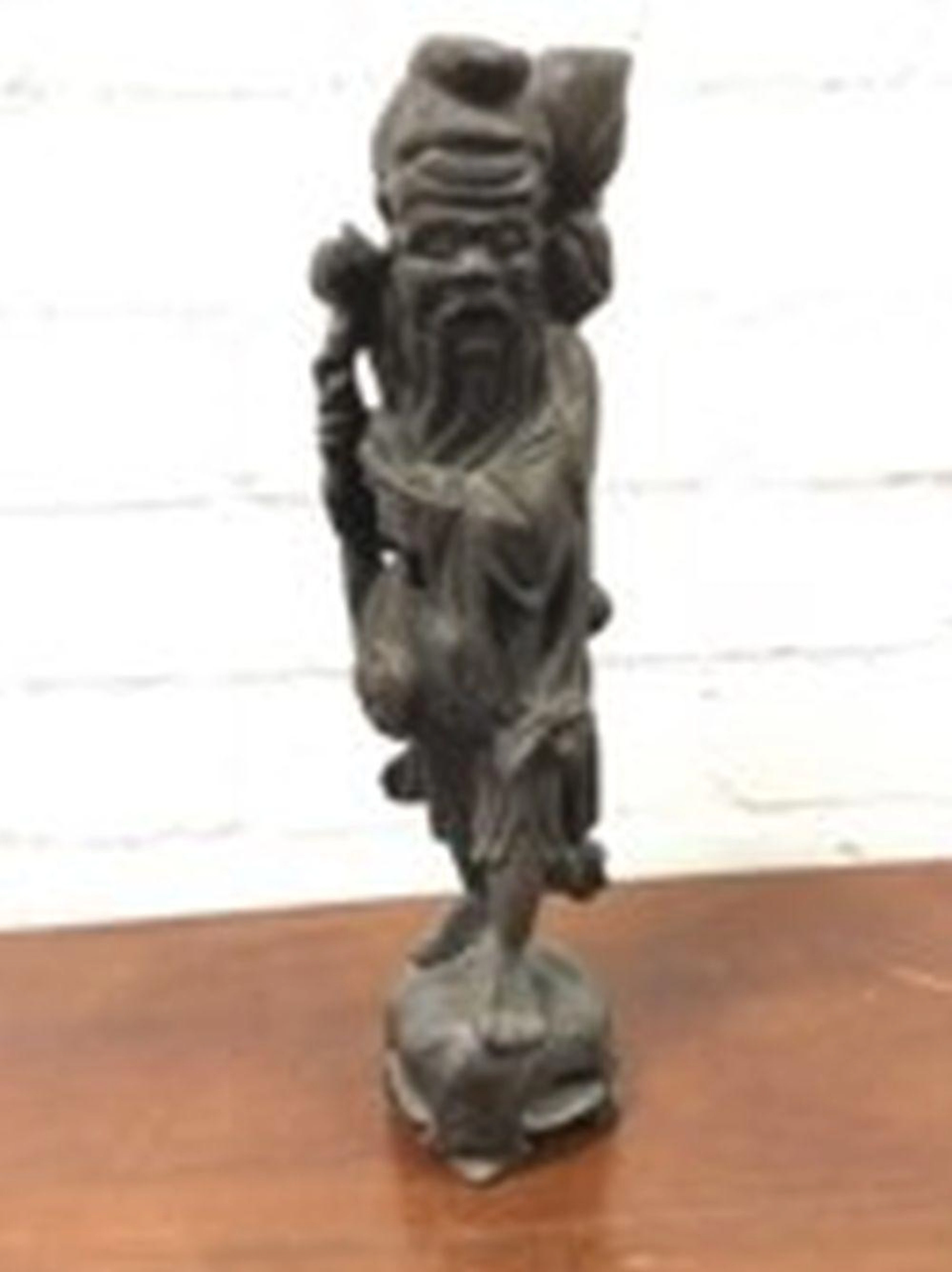 A nineteenth century Japanese carved hardwood figure of an immortal, the be