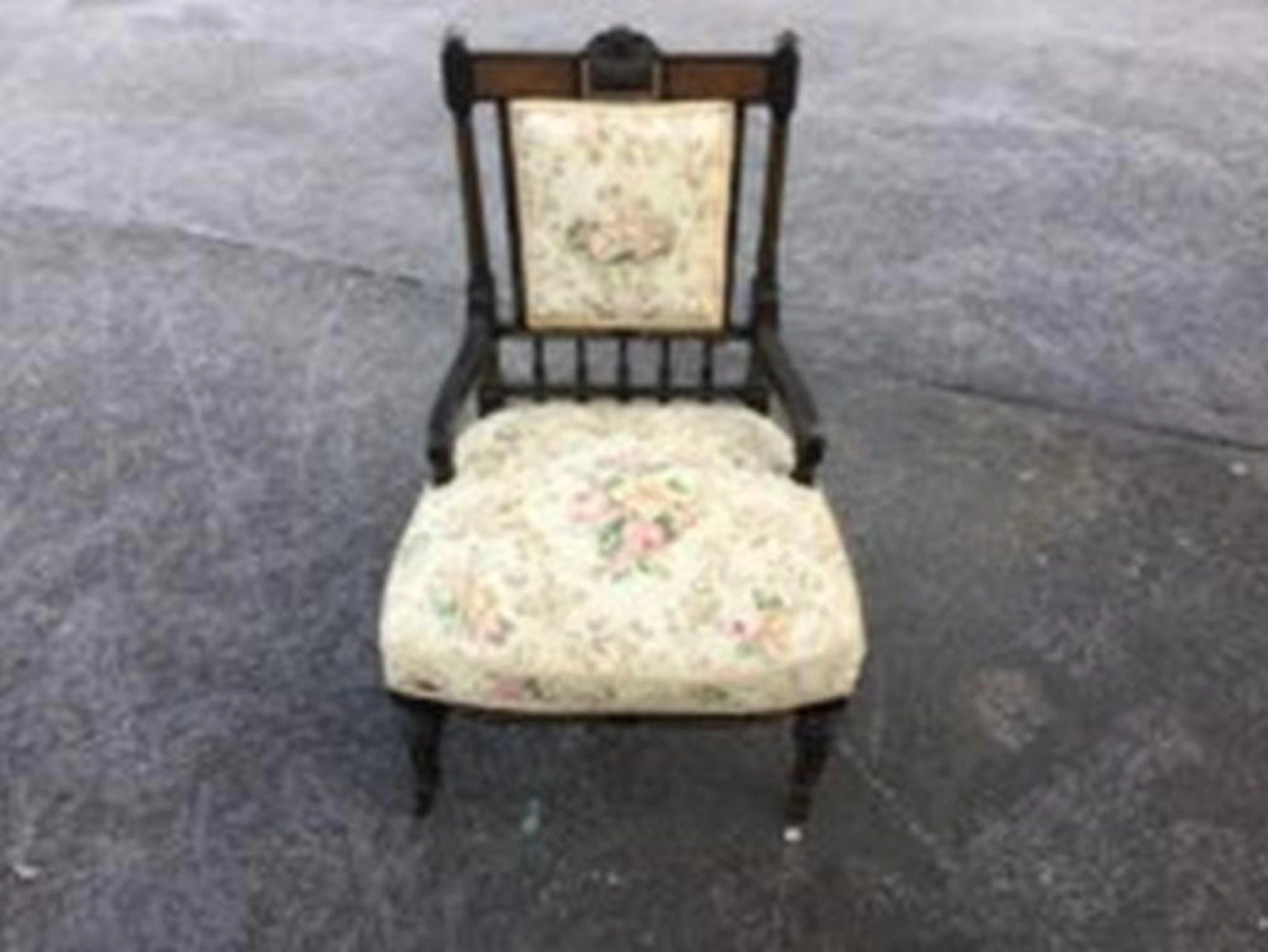 An aesthetic Victorian ebonised nursing chair, the back rail with carved b