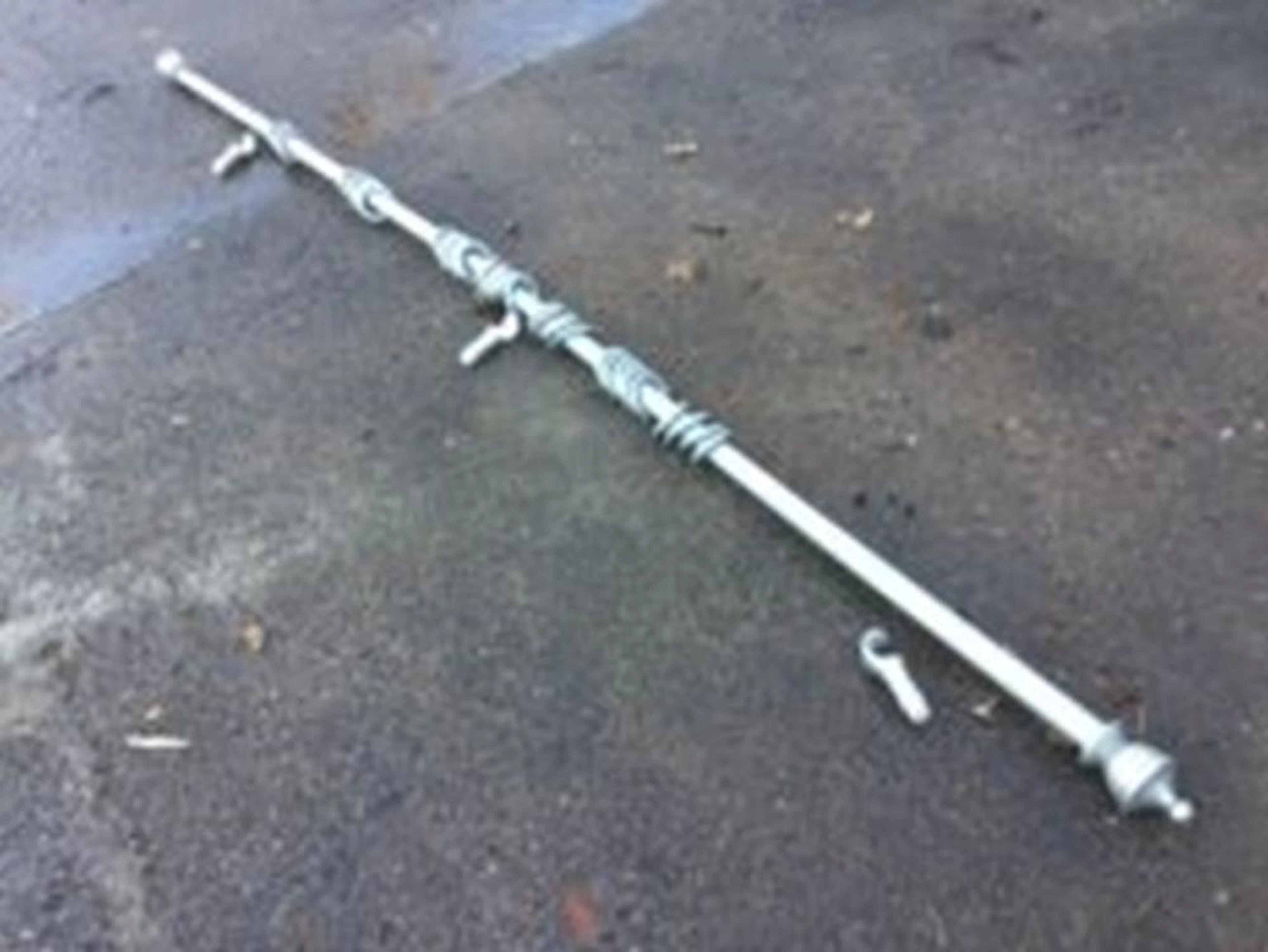 A painted 9ft 6in curtain pole with turned ends, complete with rings and wa