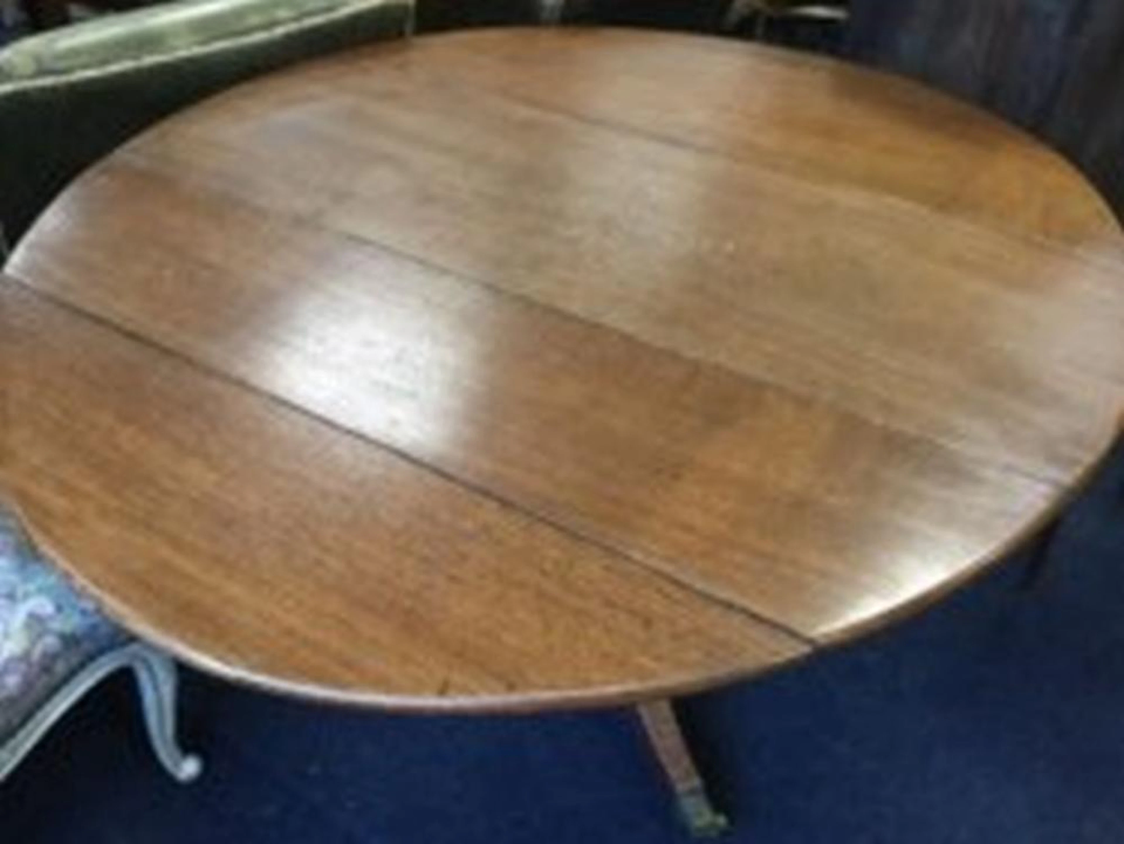 A Victorian oval oak dining table, the top with two drop-flaps supported on