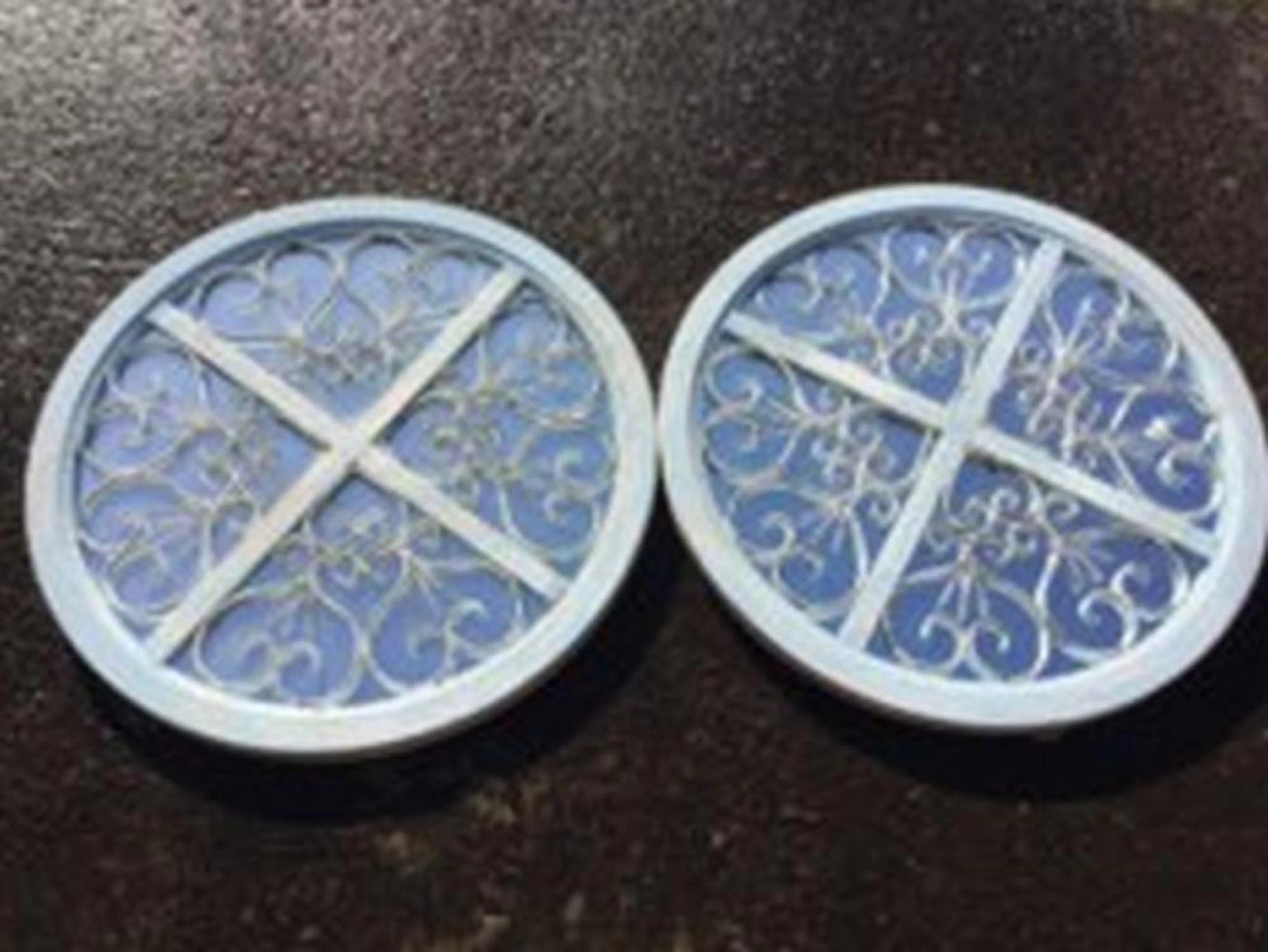 A pair of circular mirrors with moulded cross frames, the quartered panels