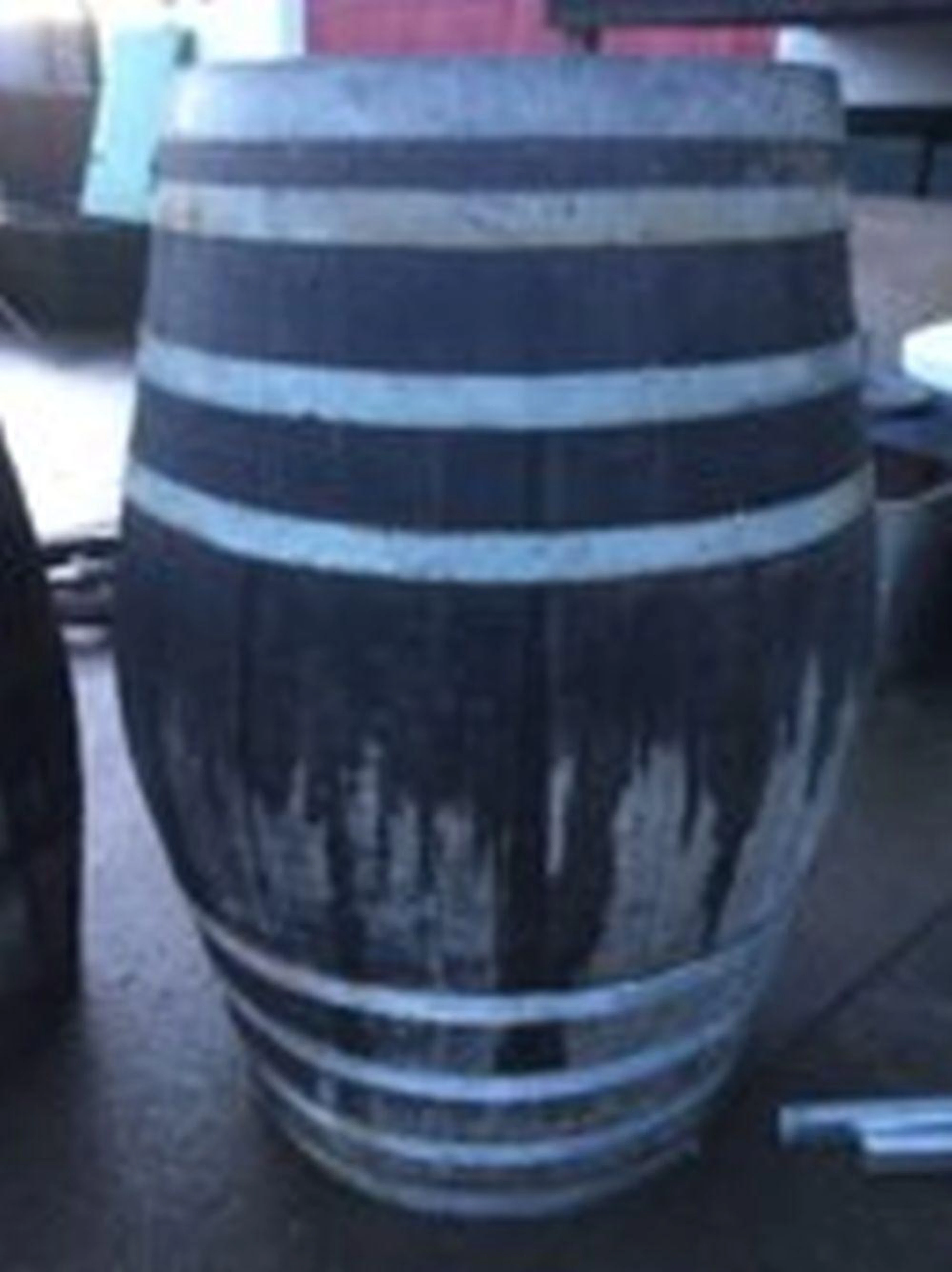 A massive oak barrel, the staves bound by eight galvanised strap bands. (5