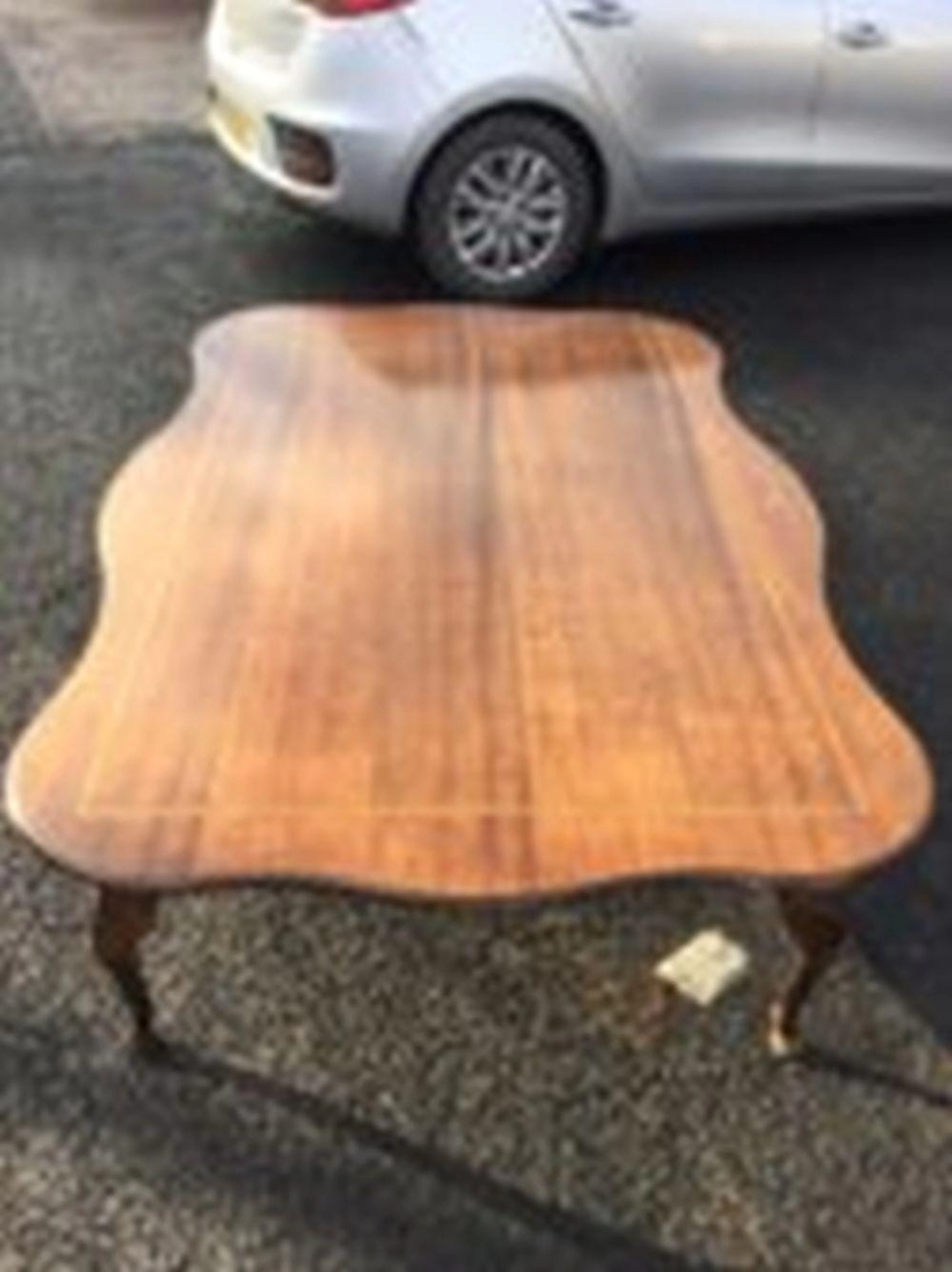 A large rectangular scalloped top coffee table, the crossbanded top on sha