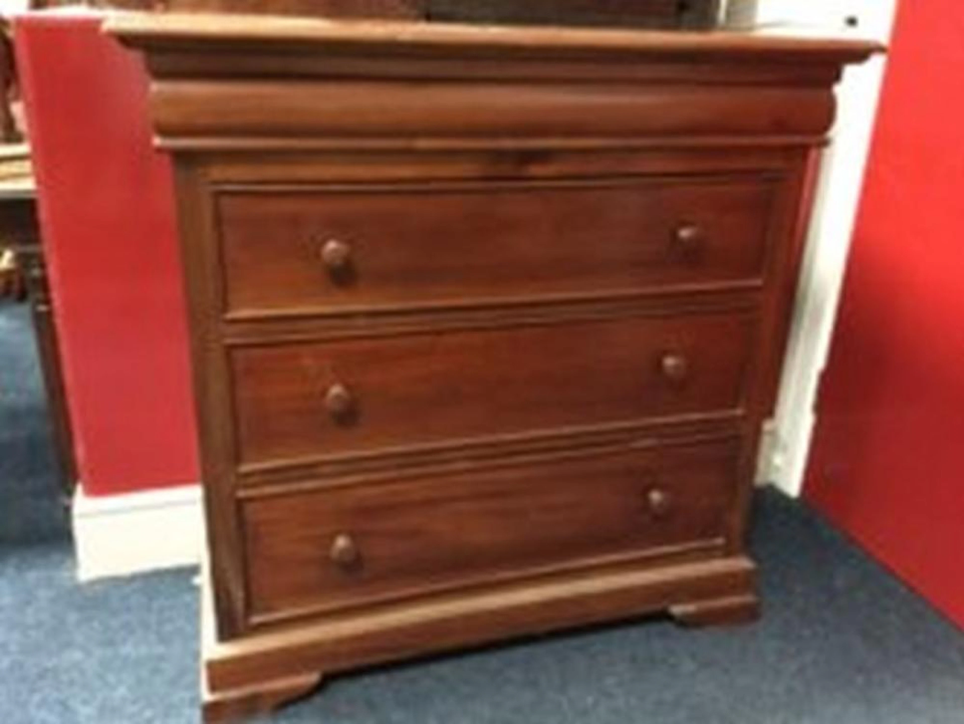 A mahogany chest with rectangular top above a cushion moulded frieze, havi
