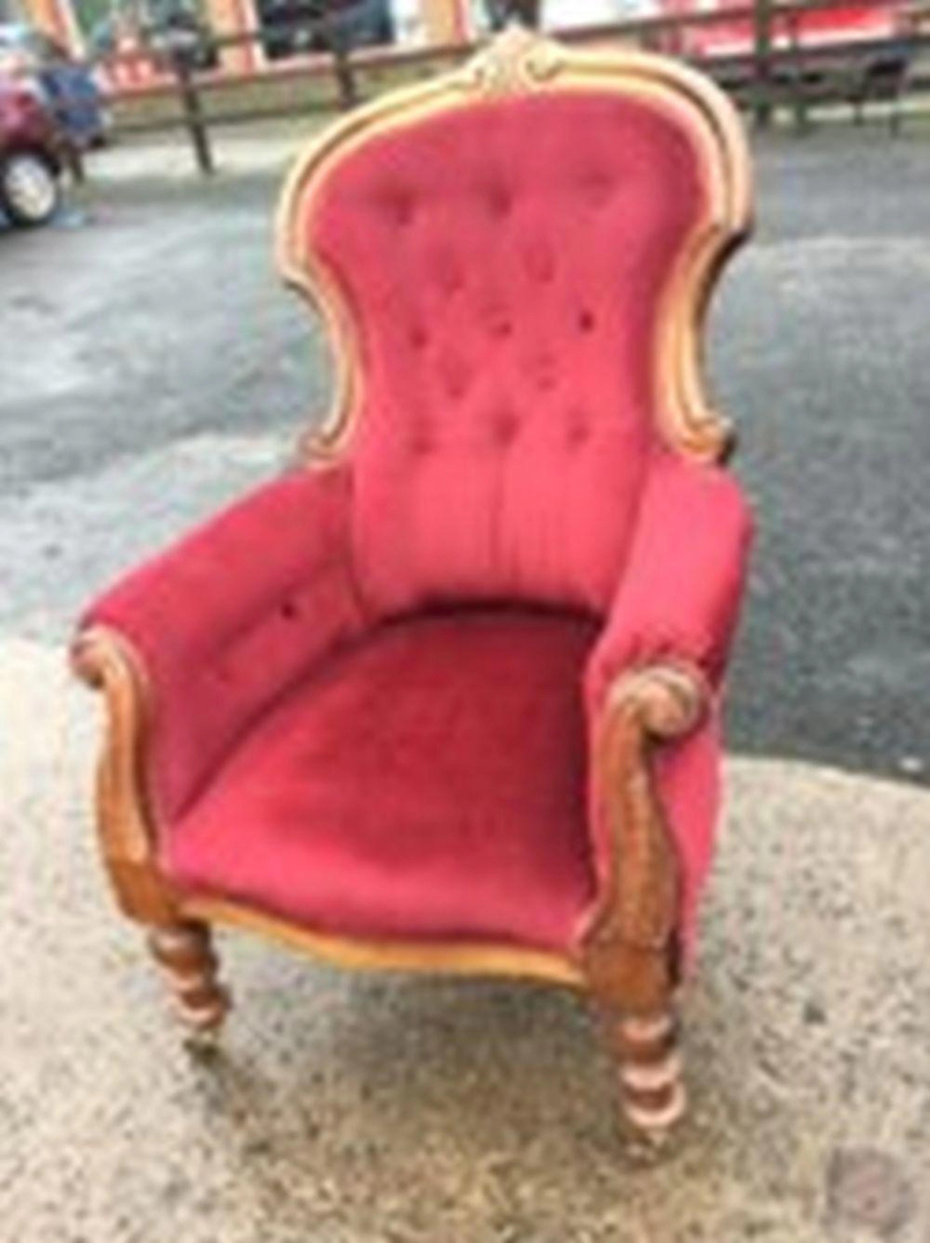 A Victorian button upholstered armchair, the back with carved crest on mou