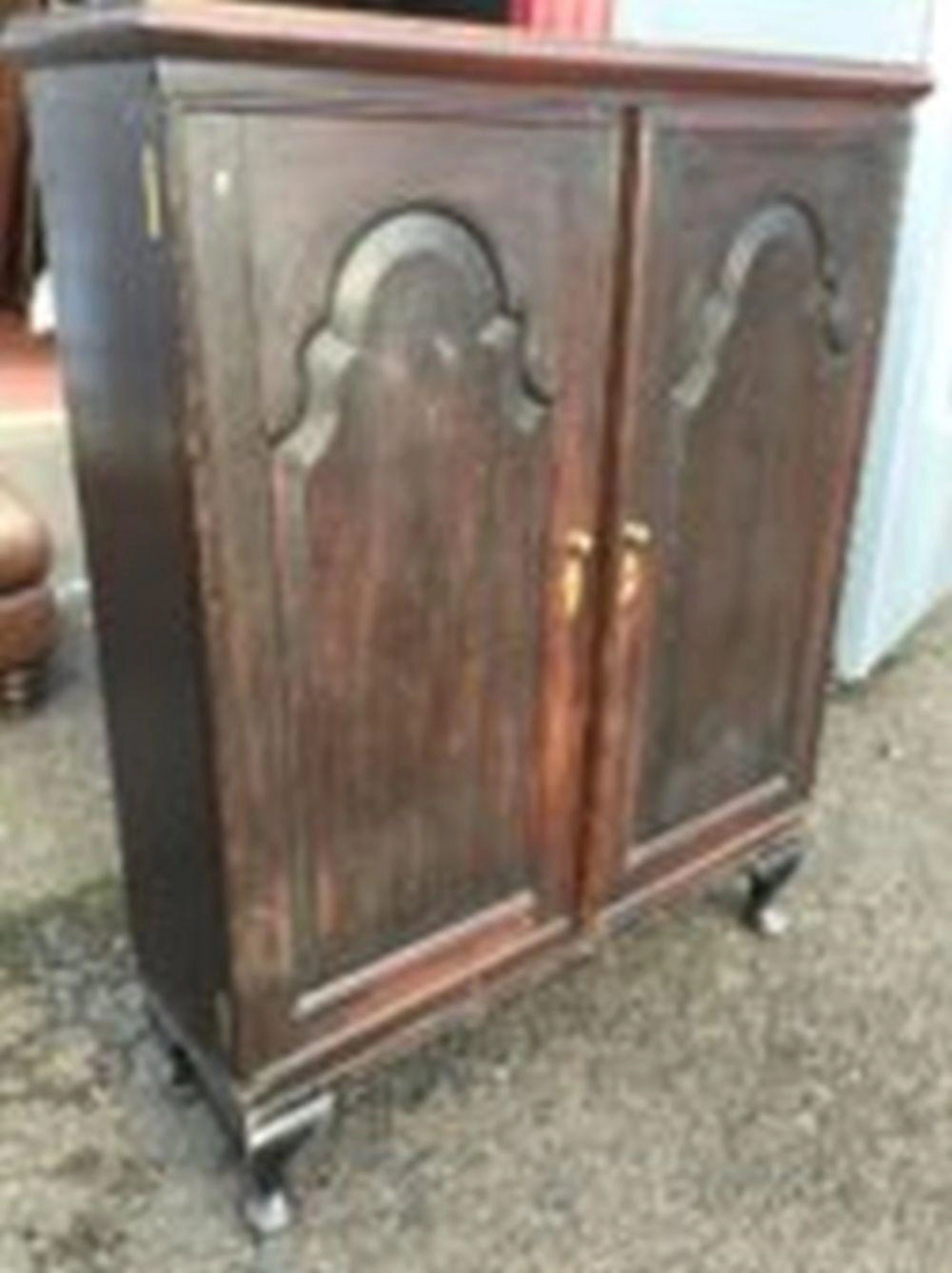 An antique oak cupboard with later restorations, having rectangular moulded