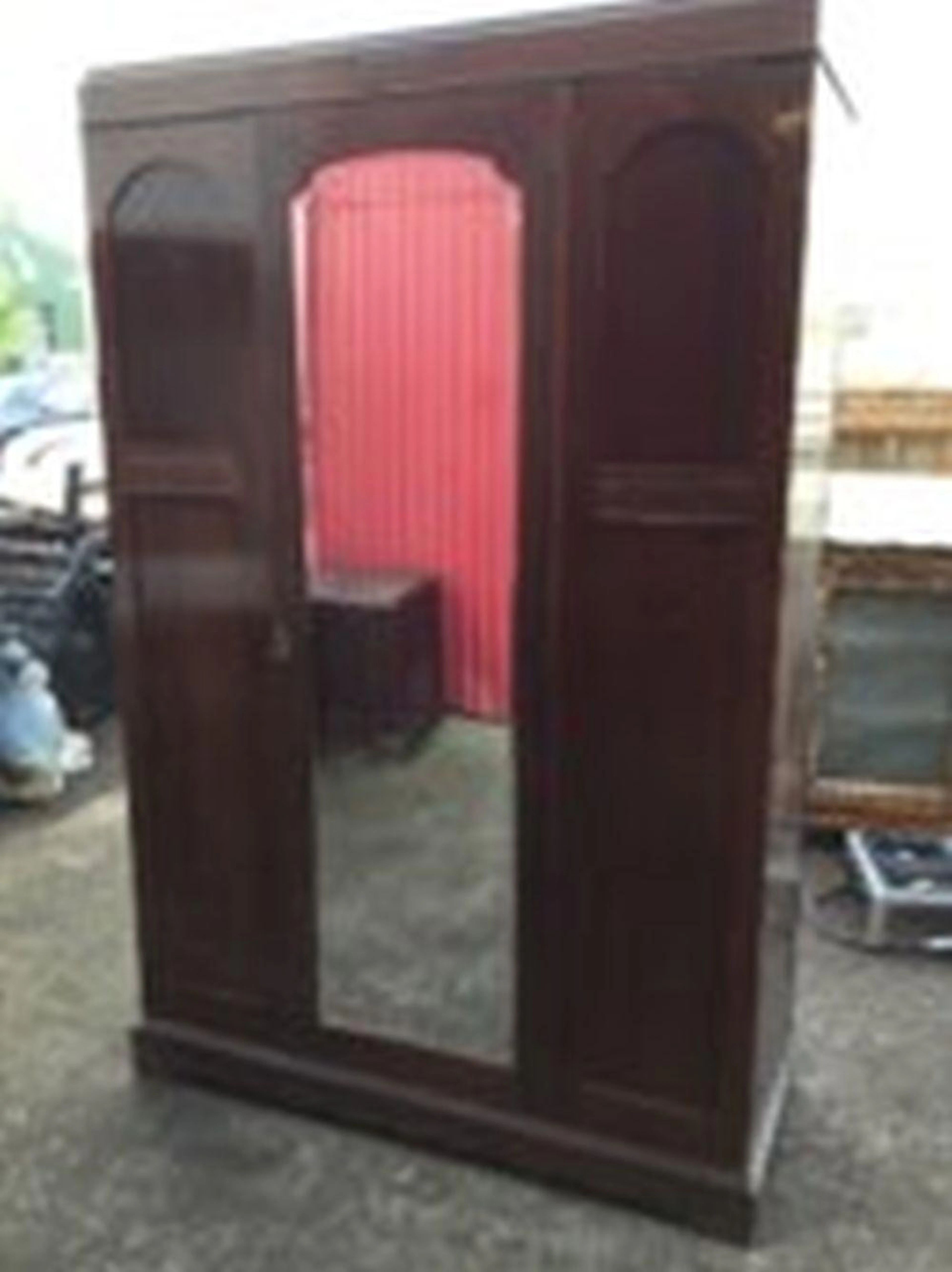 A stained wardrobe with caddy top and central arched bevelled mirror door f
