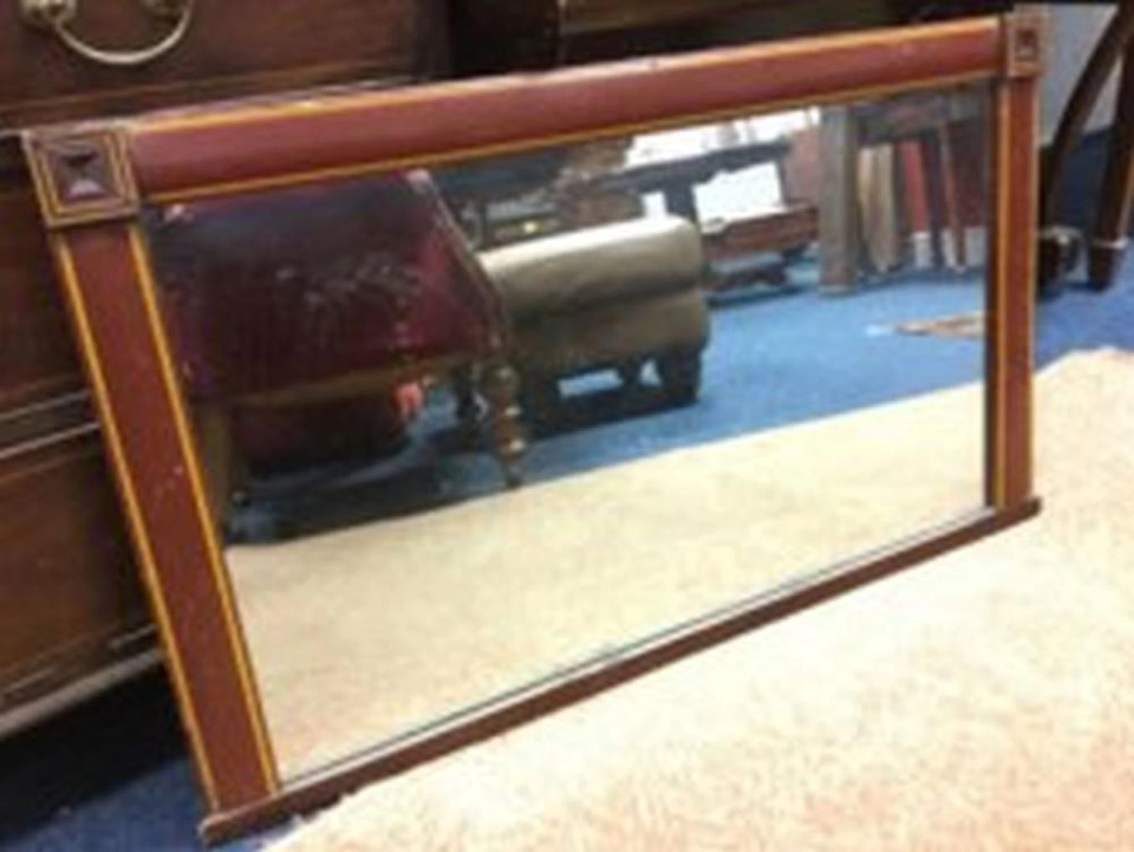 A rectangular overmantle mirror, the cushion moulded frame with crossbanded