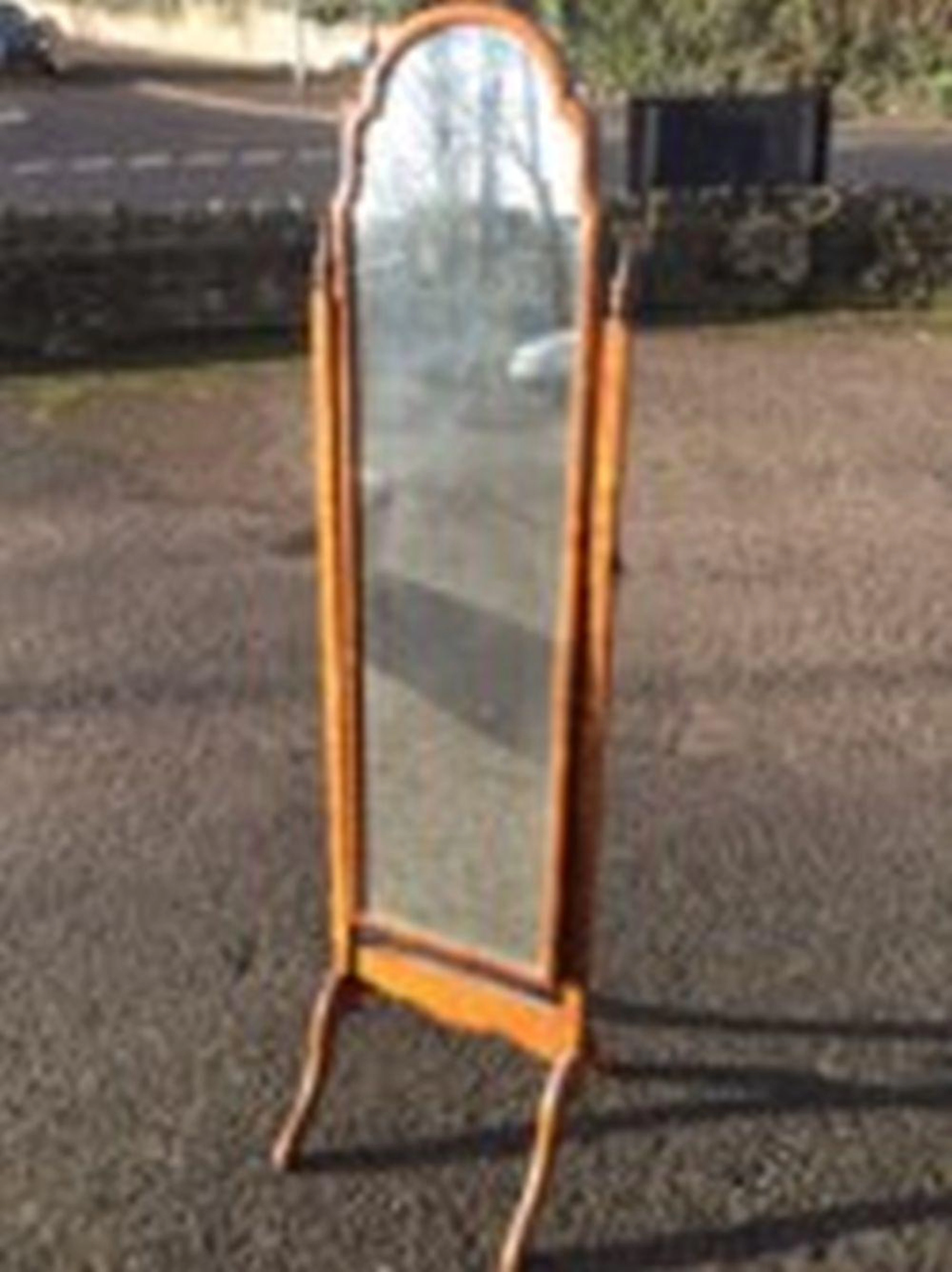 A Queen Anne style walnut cheval mirror, the rectangular arched plate in c