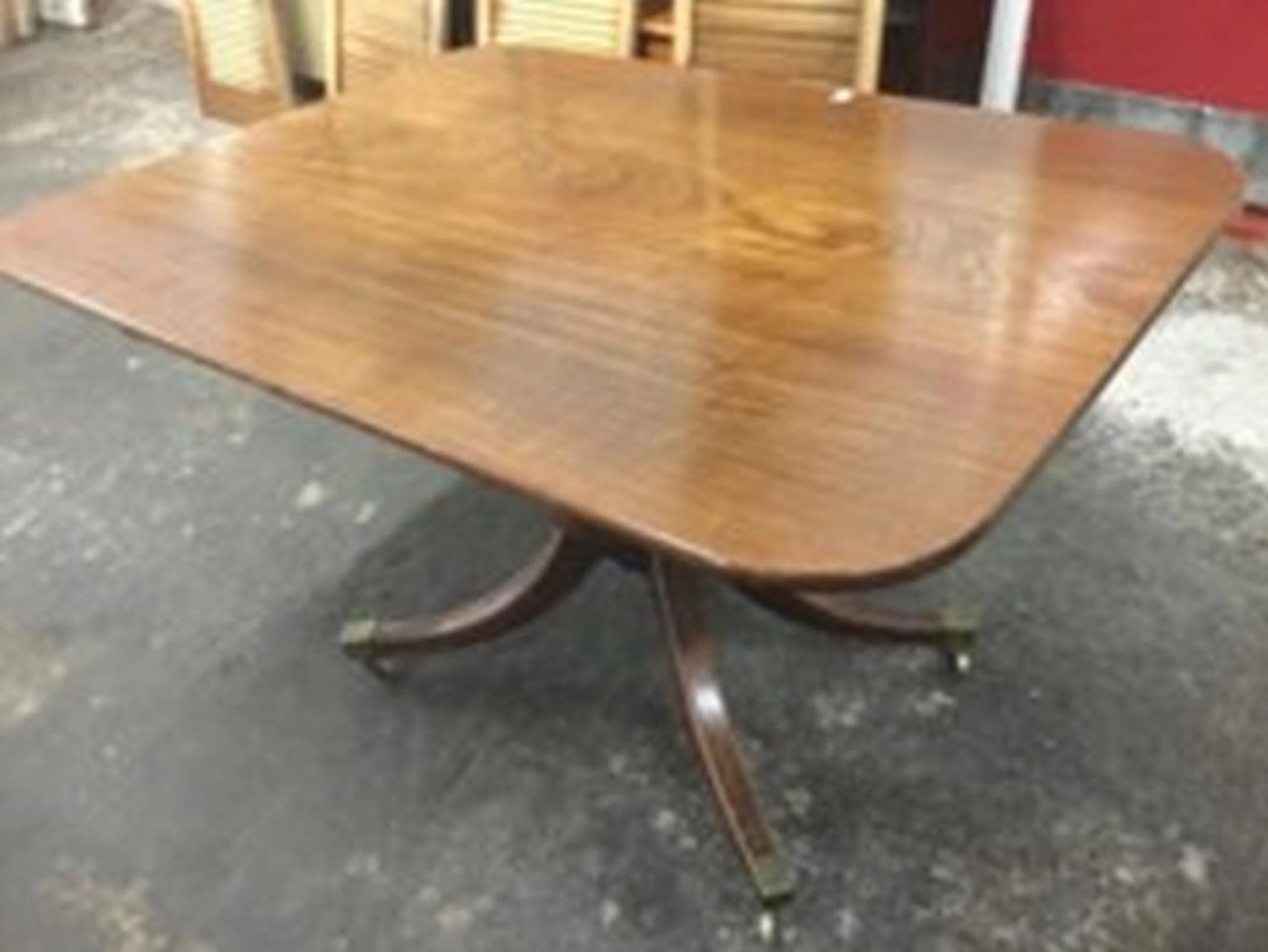 A regency mahogany breakfast table, the rectangular single-piece square to