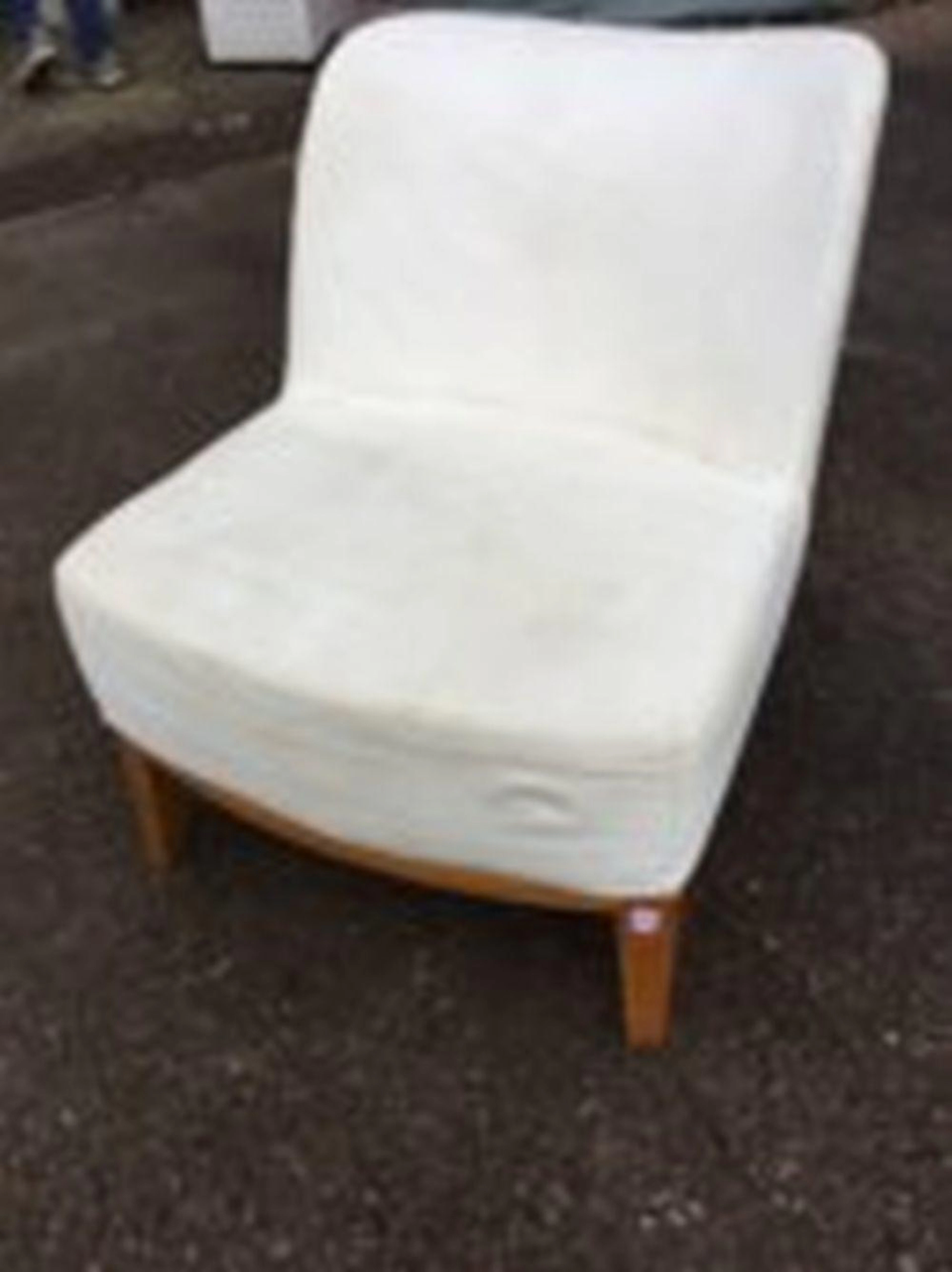 A contemporary upholstered chair with shaped back and bowfronted sprung sea