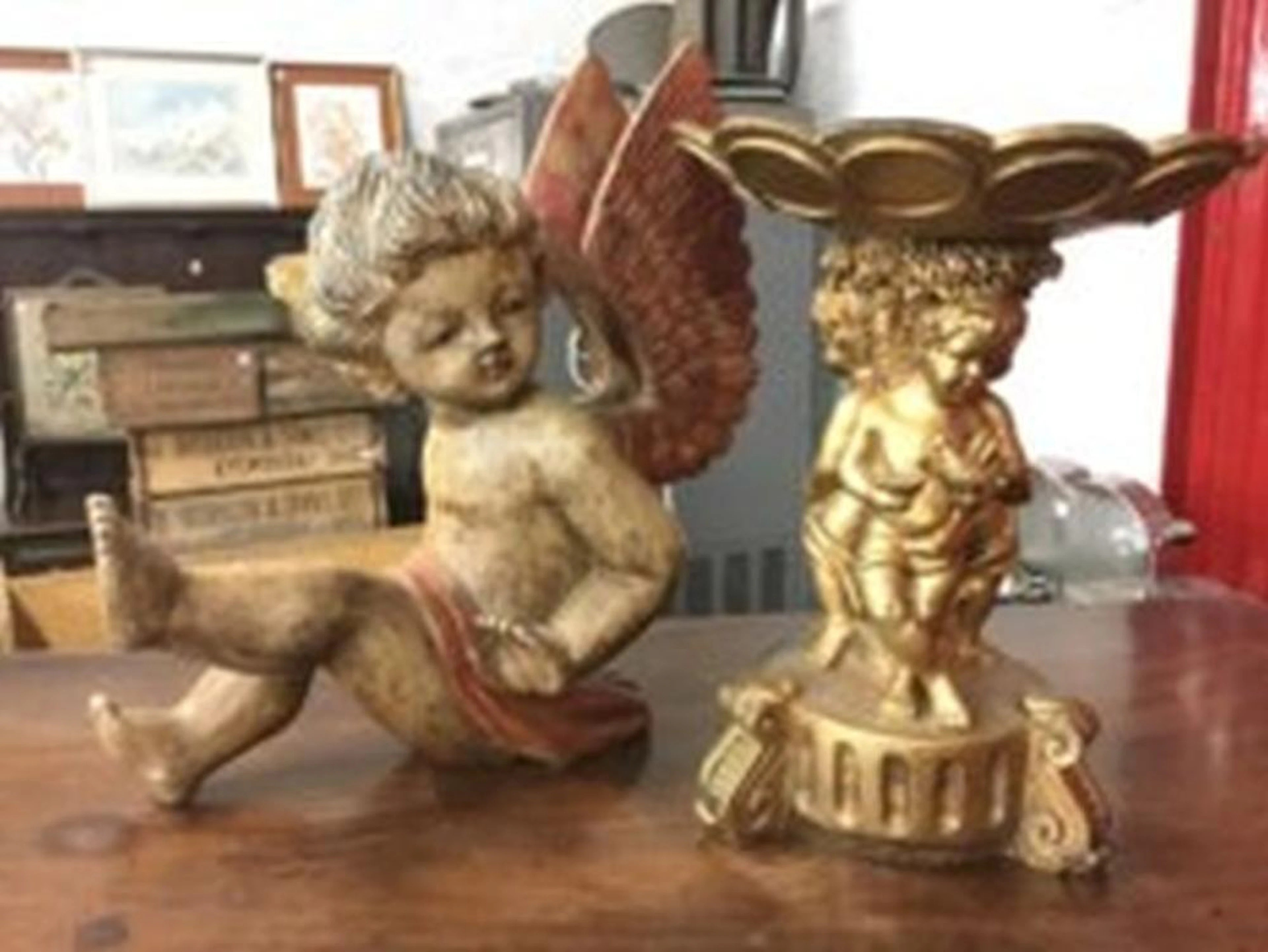 A painted and carved wood winged cherub; and a gilded comport with circula
