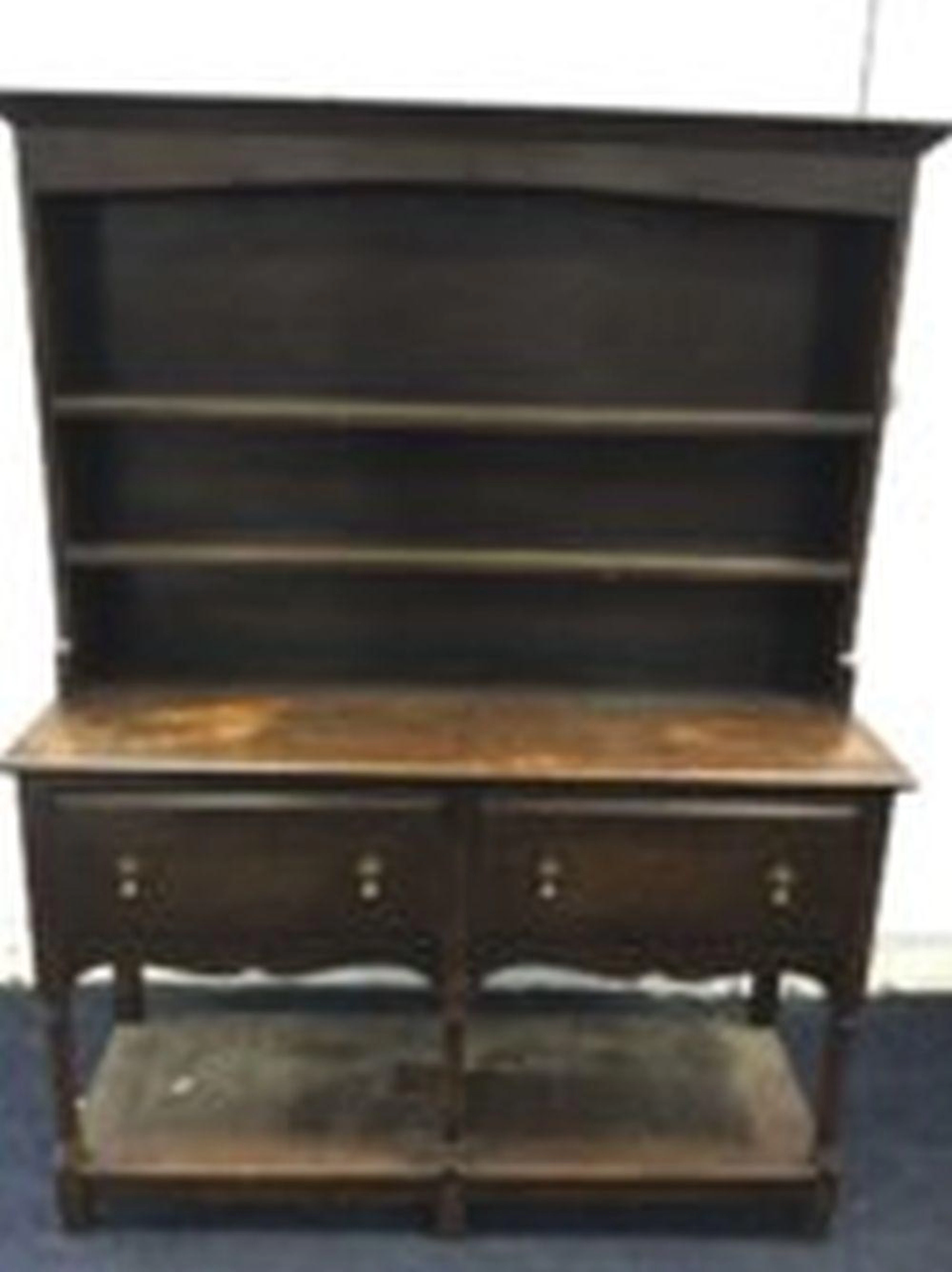An Edwardian oak dresser, the delft rack with ogee cornice above an arched