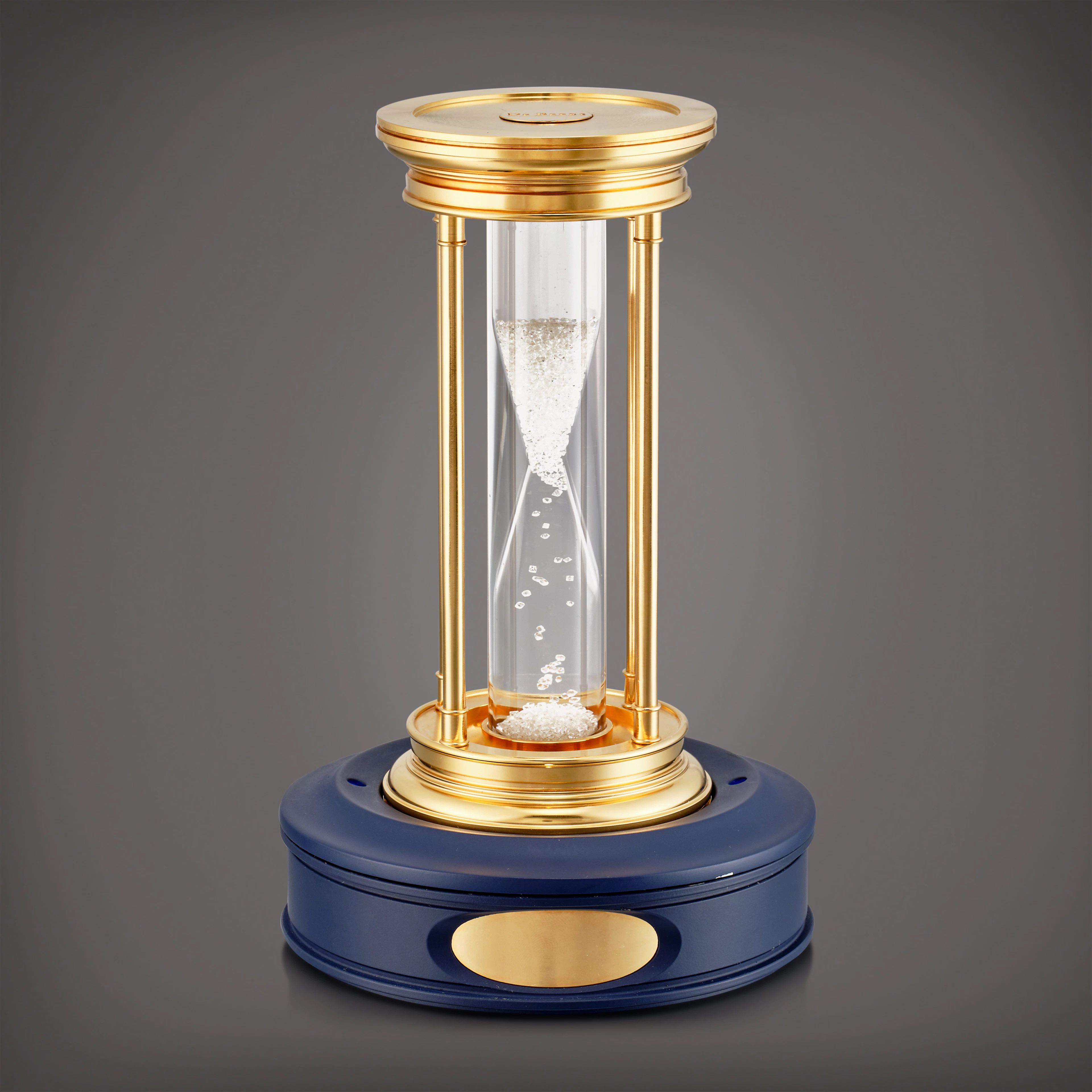 A limited edition gilt brass hourglass with floating diamonds