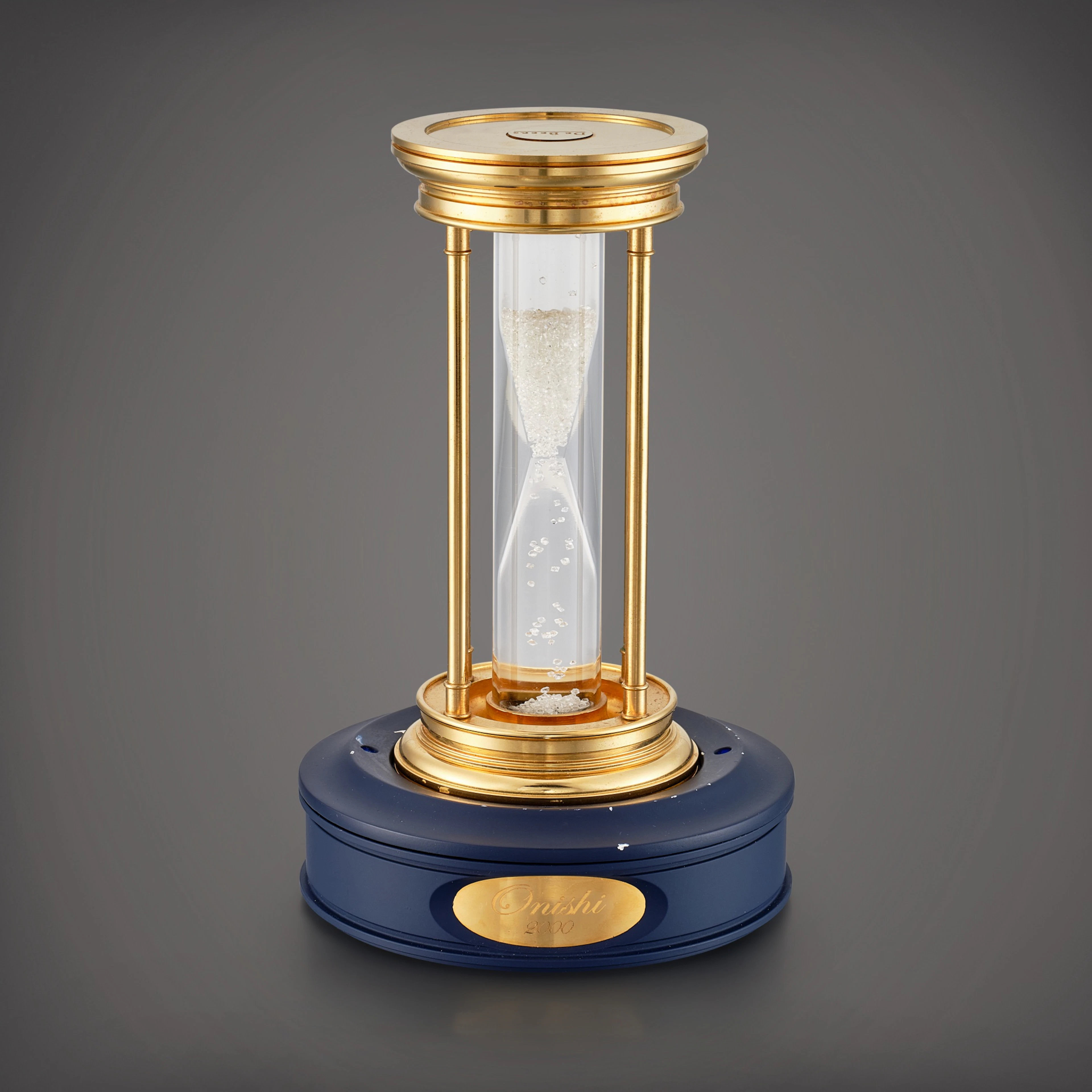 A gilt brass hourglass with floating diamonds