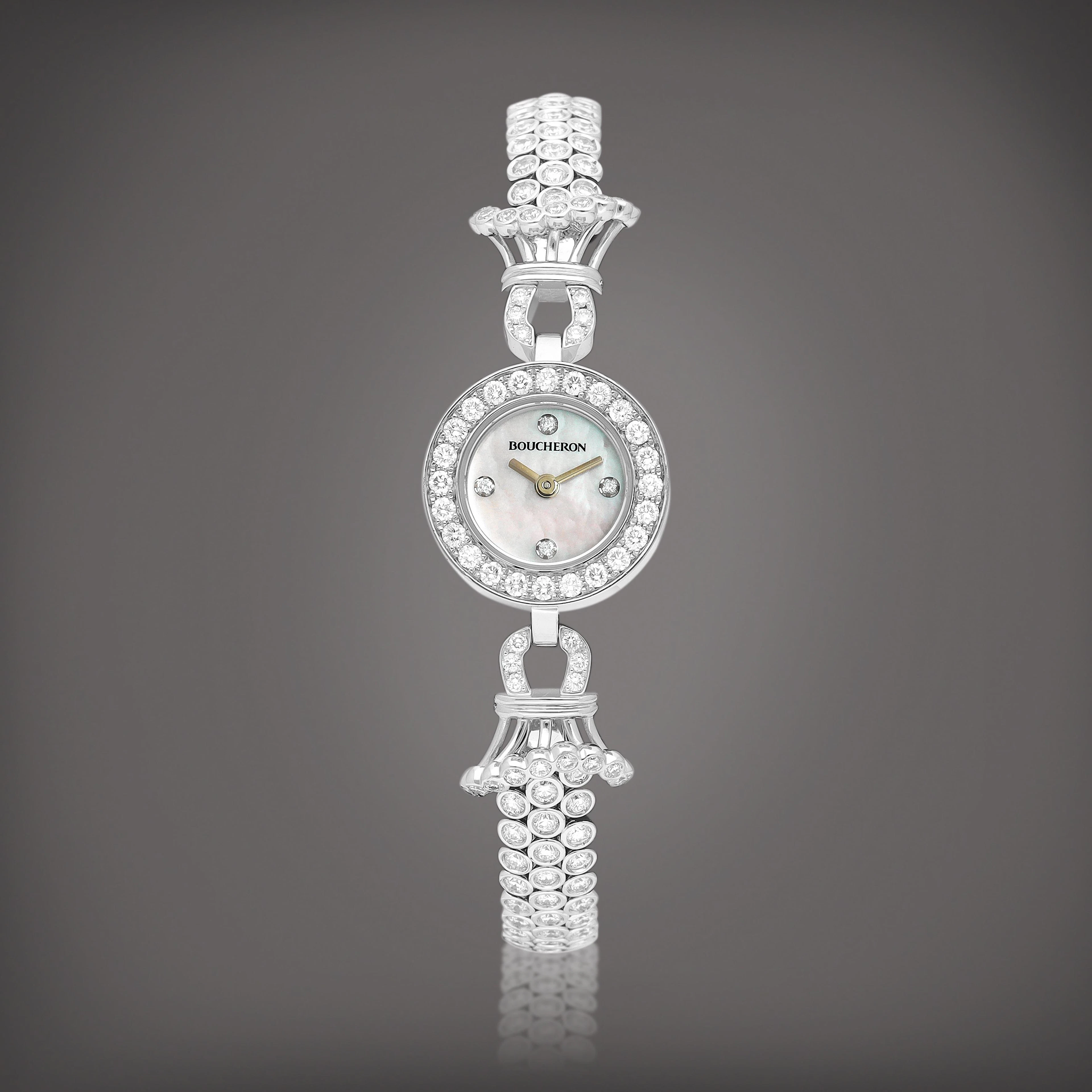 A white gold and diamond-set bracelet watch with mother-of-pearl dial