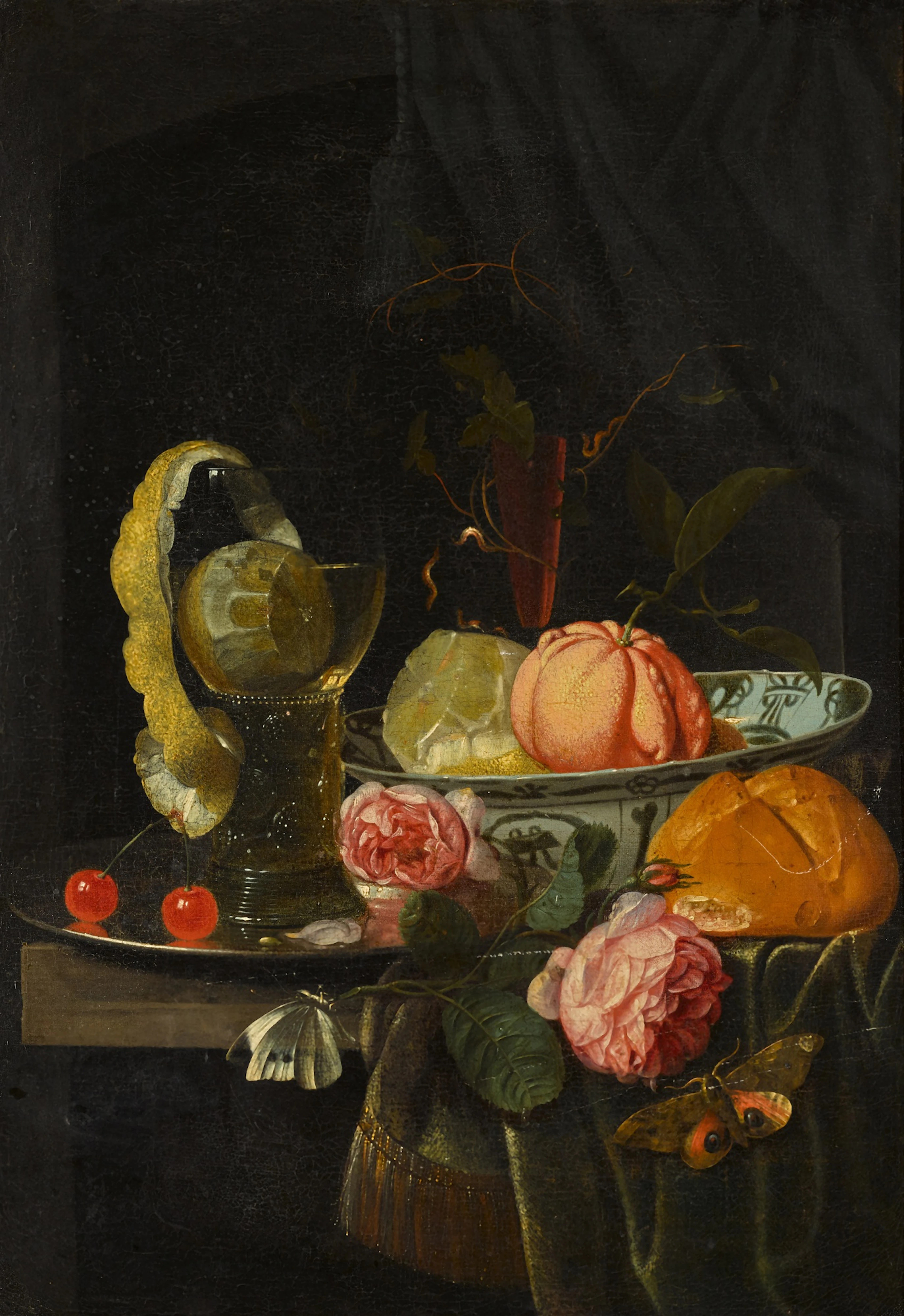 Still life of a clementine and peeled lemon in a porcelain bowl
