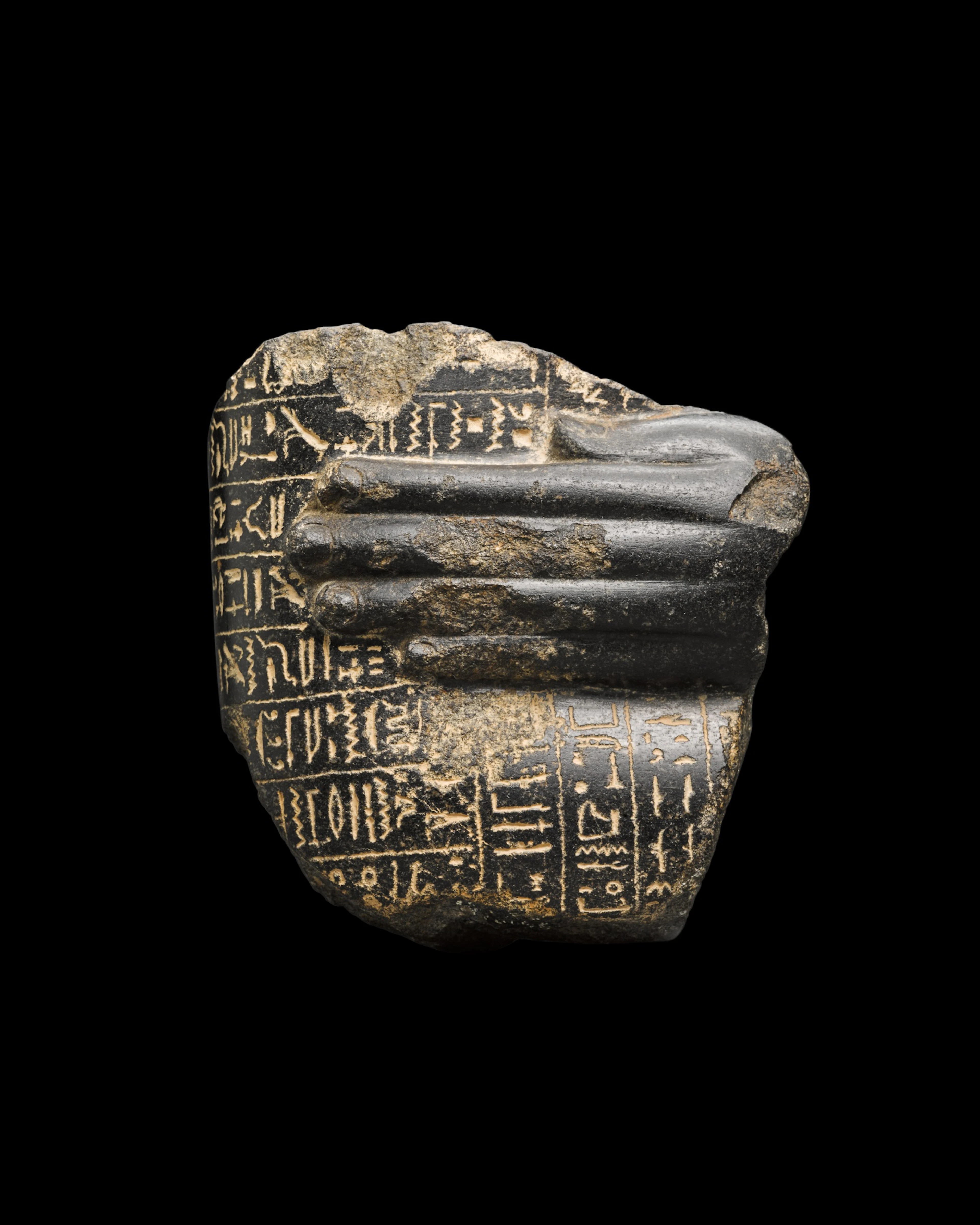 An Egyptian Granite or Basalt Healing Block Statue Fragment