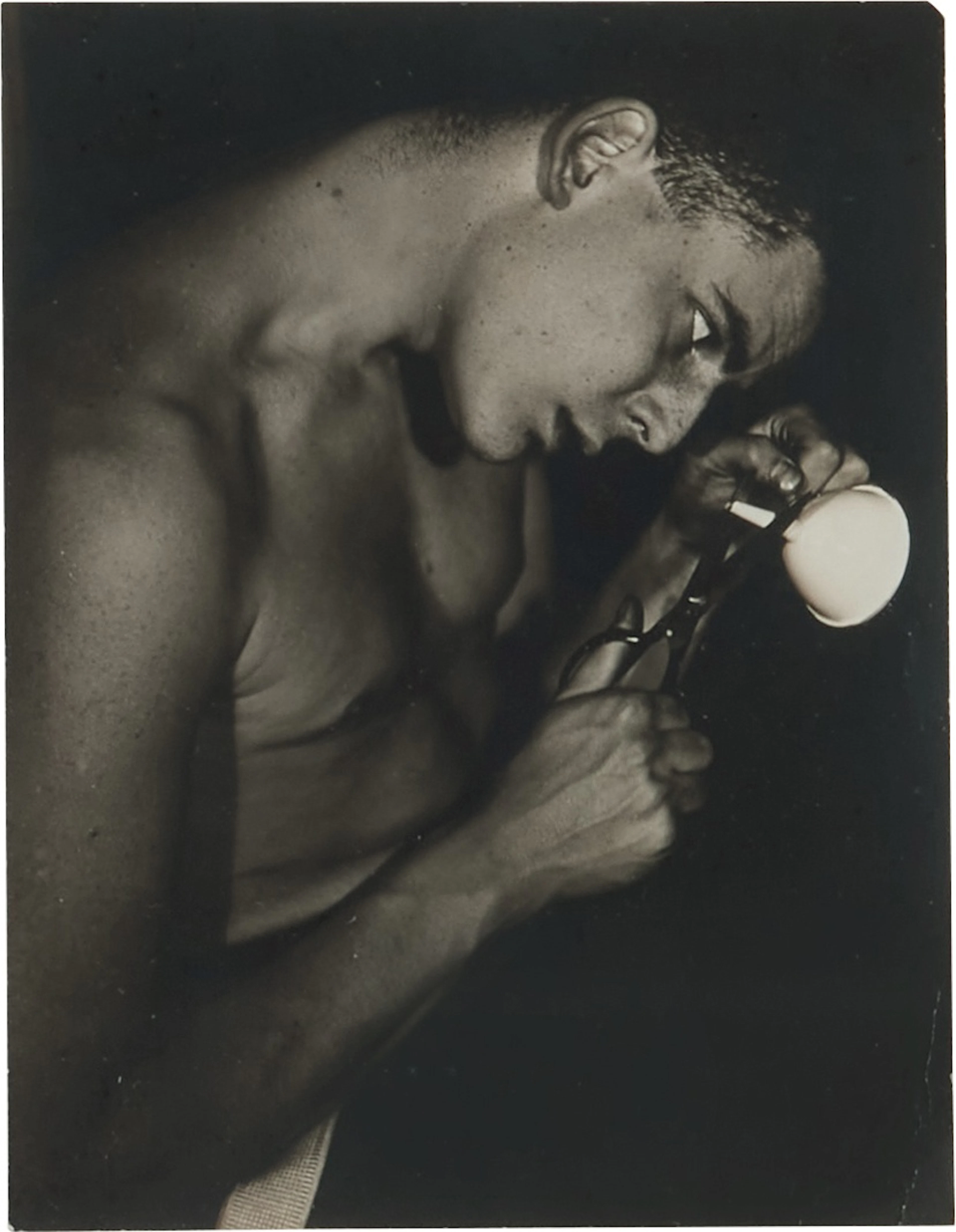 Lincoln Kirstein Attempting to Cut the Stem of a Funnel
