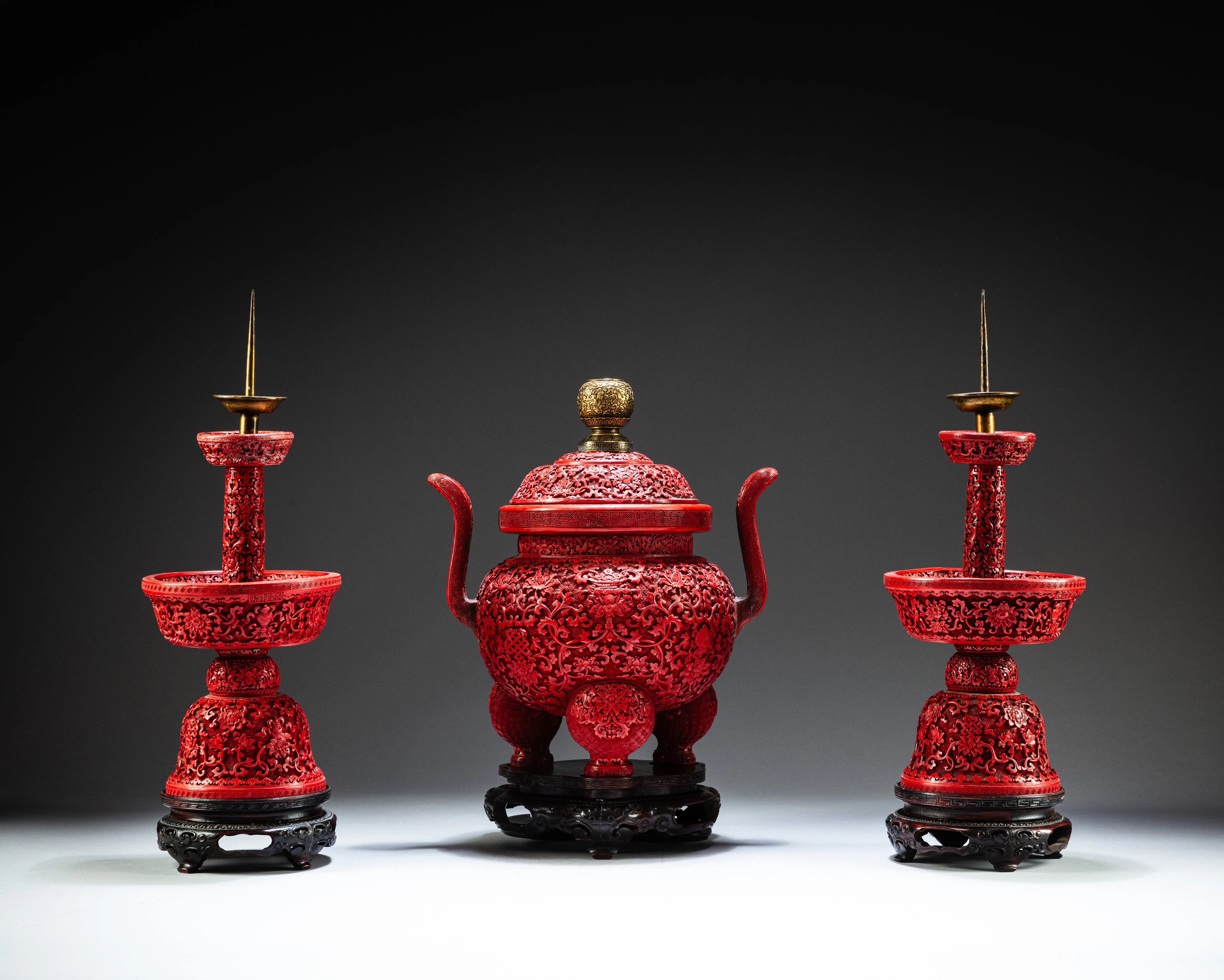 A pair of carved cinnabar lacquer candlesticks and a...
