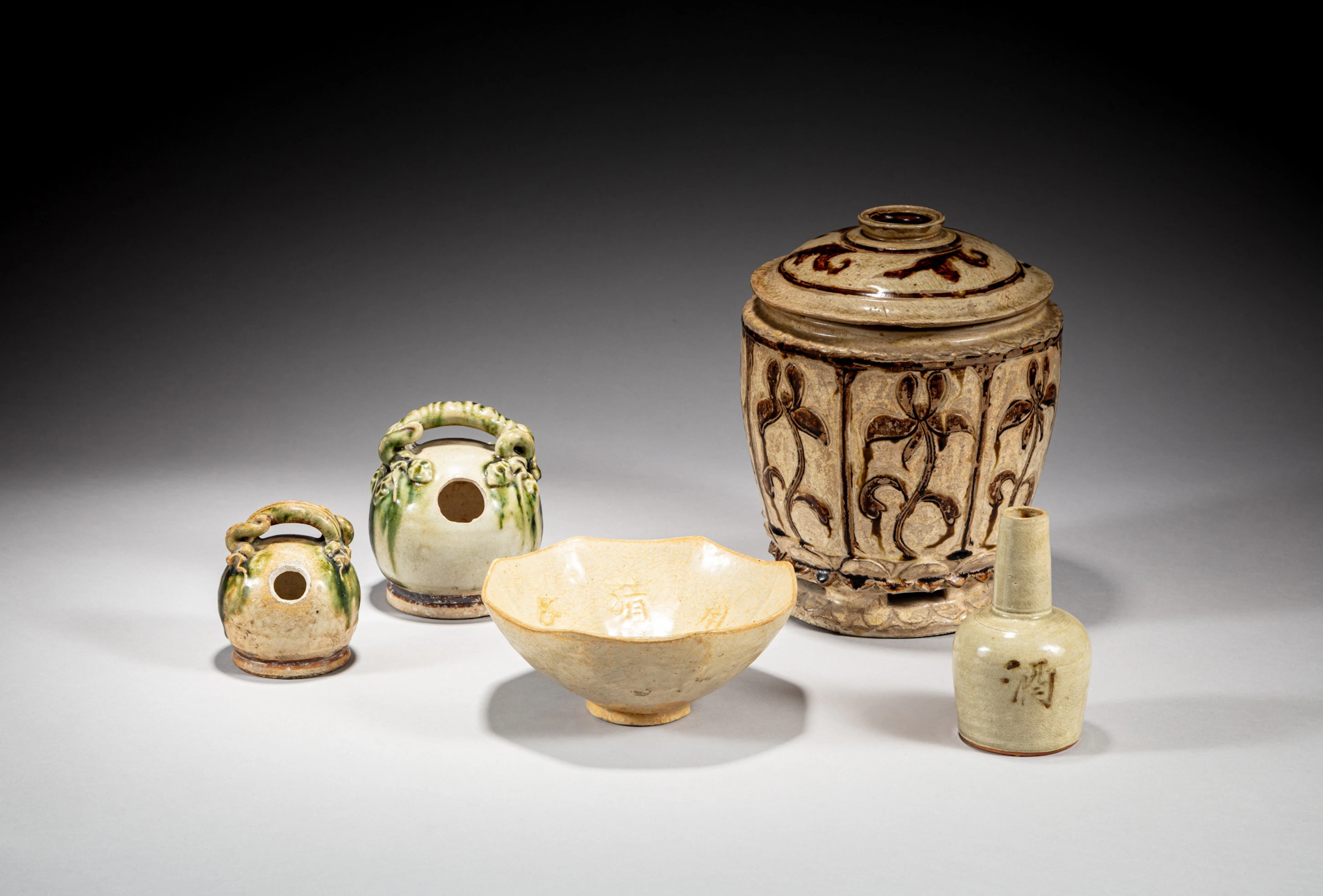 A group of five cream-glazed ceramics