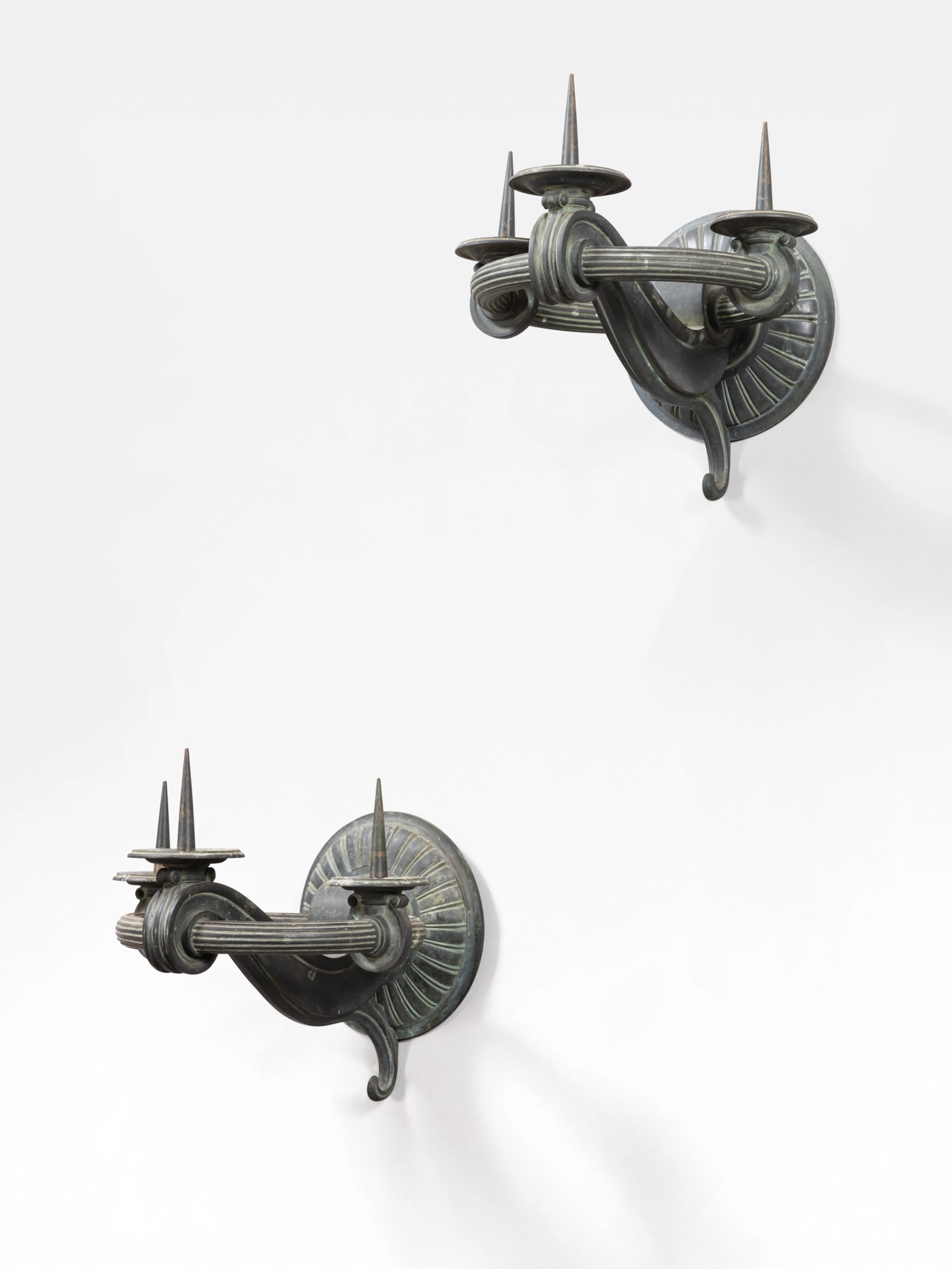 A pair of patinated bronze two-light wall-lights