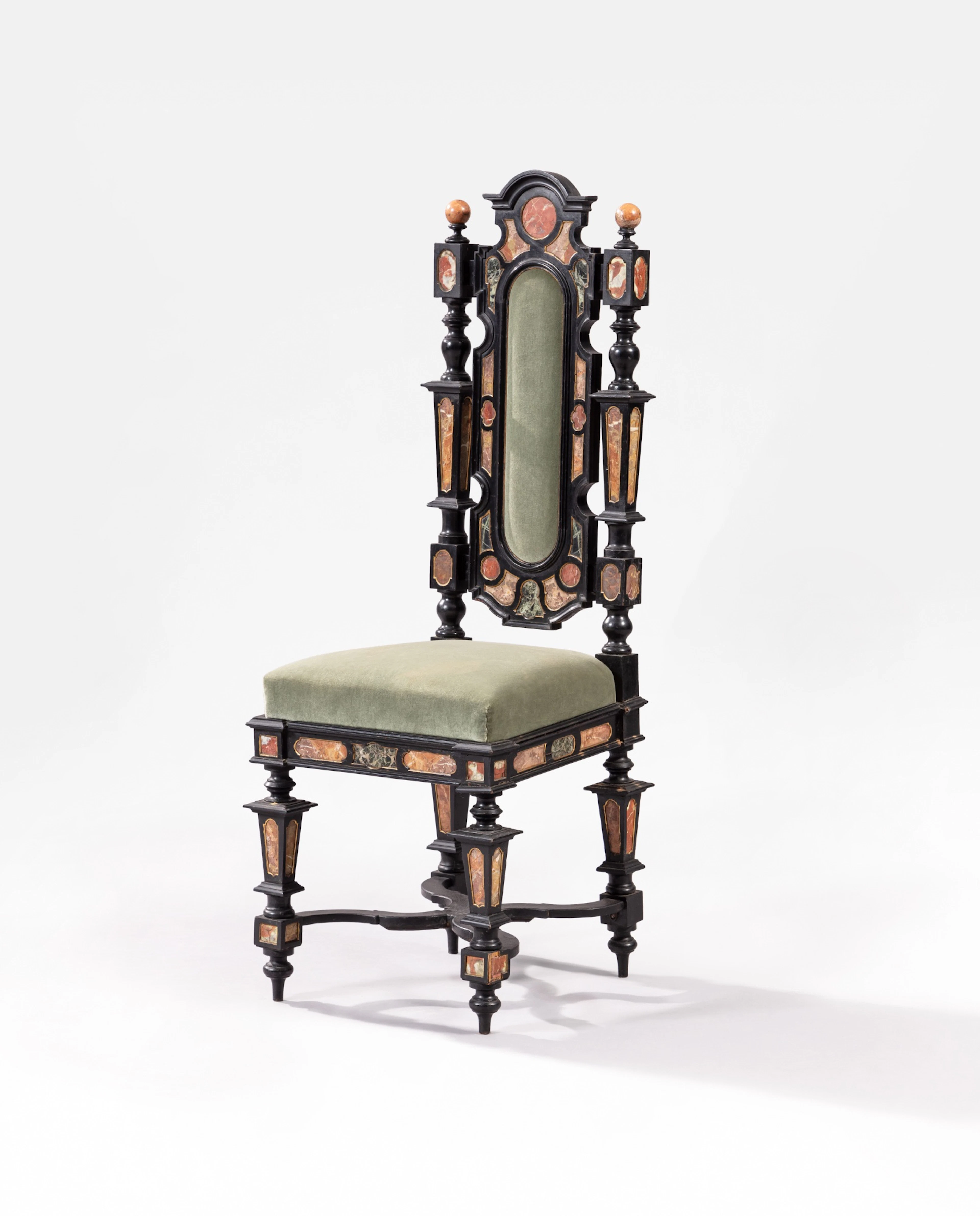 An ebonized wood and marble chair