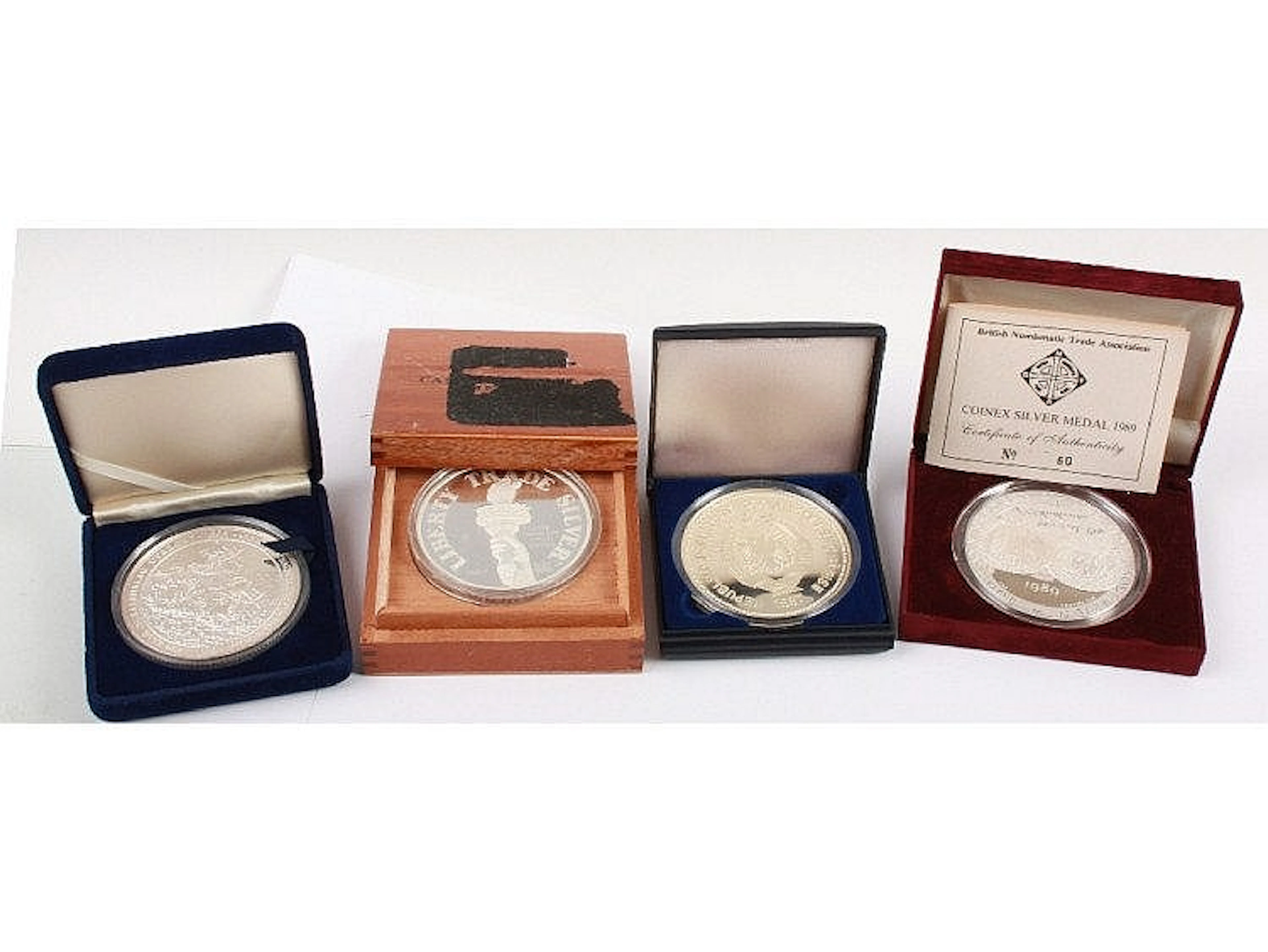 Four 5 ounce fine silver proof coins, including a