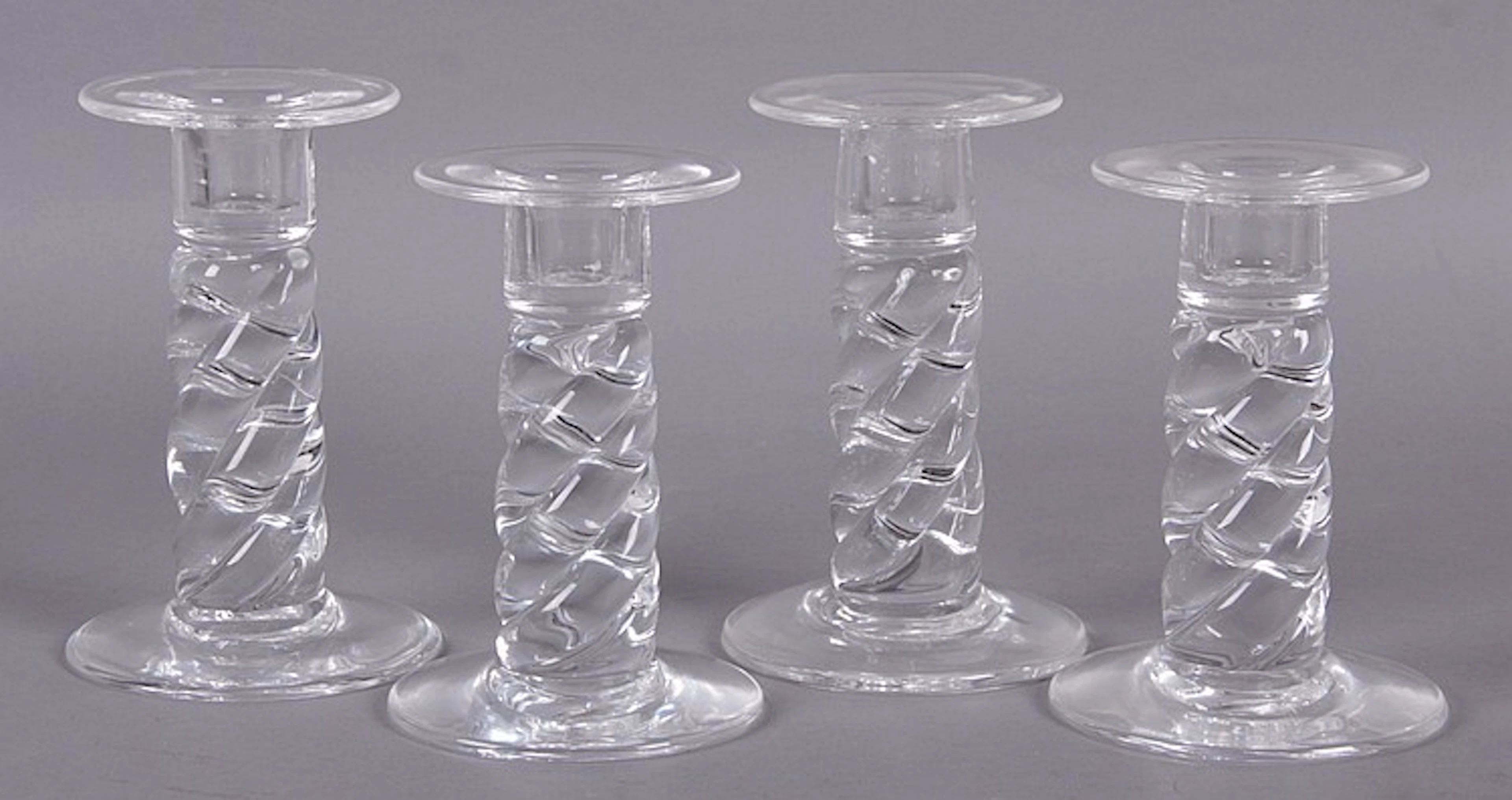 A Set of Four Steuben Glass Candlesticks