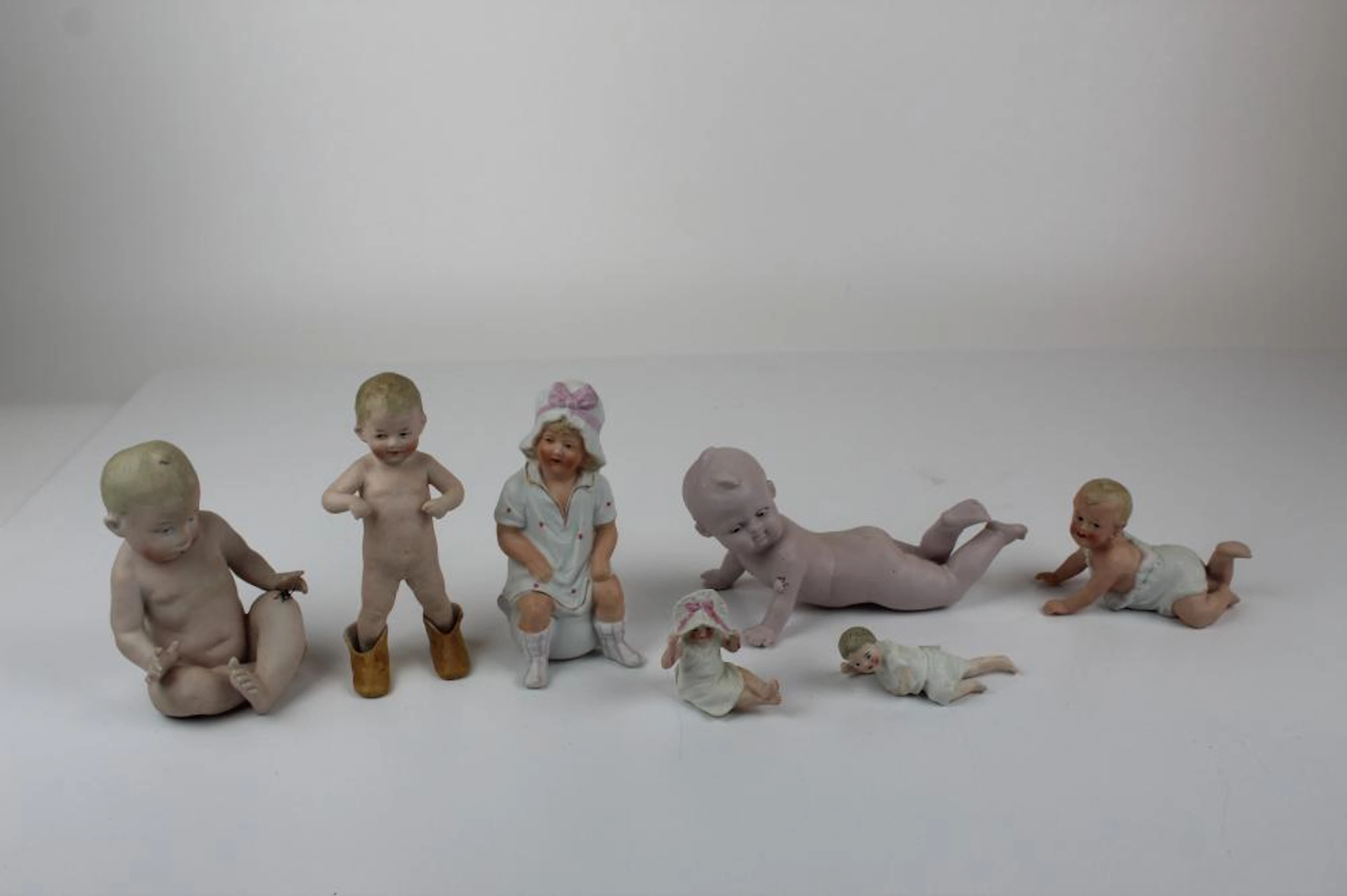 (7) Bisque Piano Babies