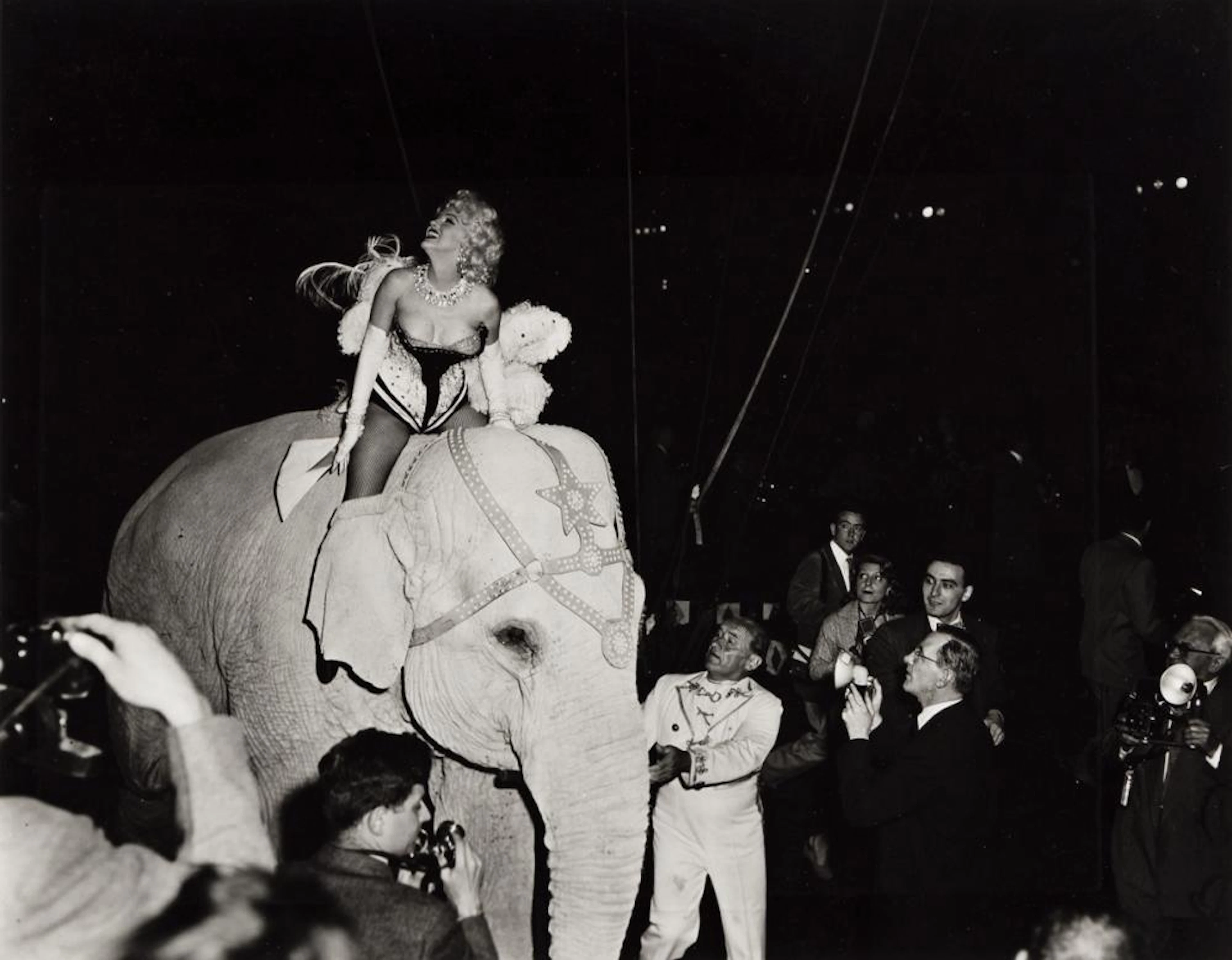 MILTON GREENE (1922-1985) Marilyn Monroe riding a pink...