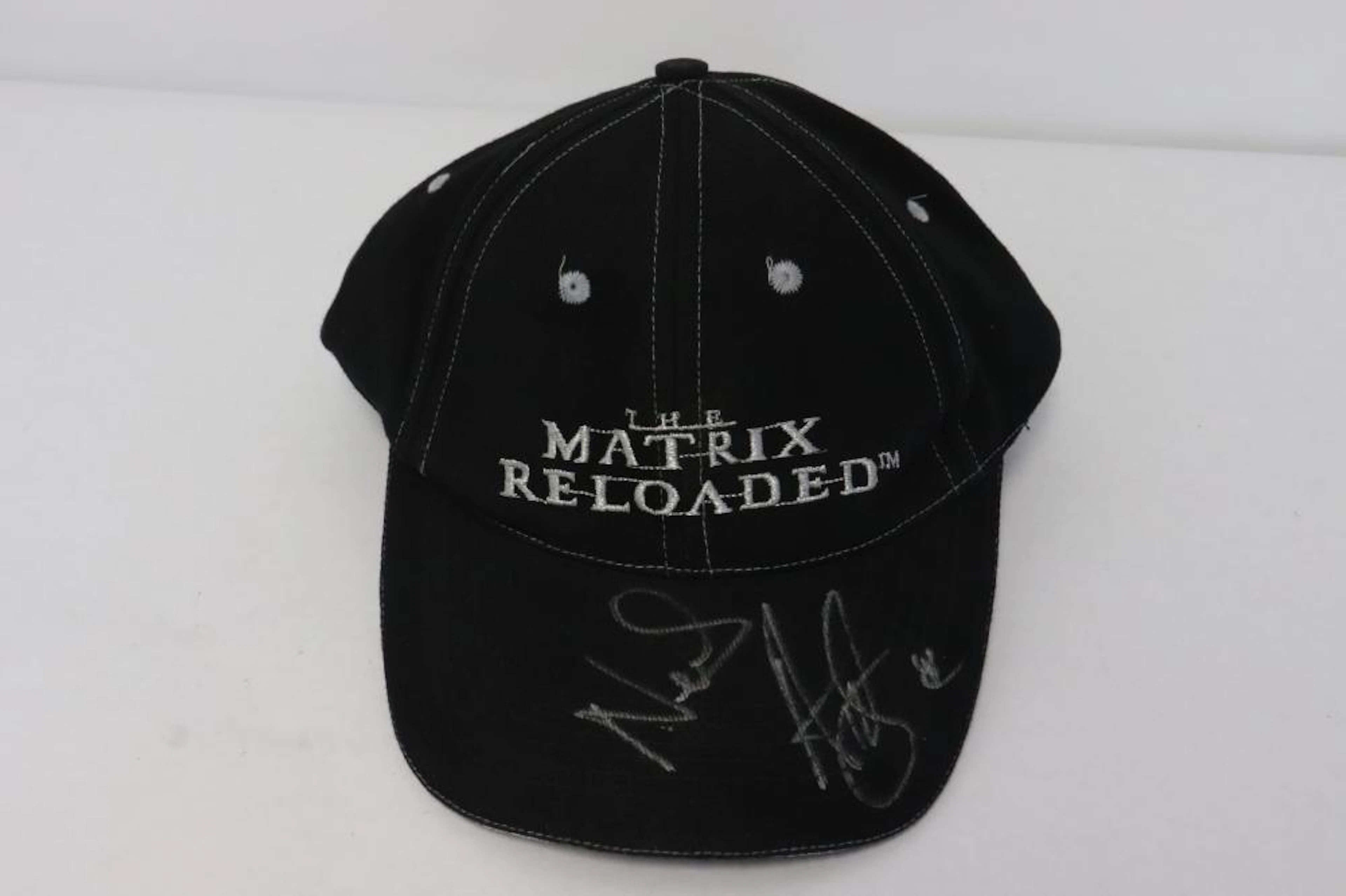 A hat "matrix reloaded" signed by "Neil" Keanu Reeves