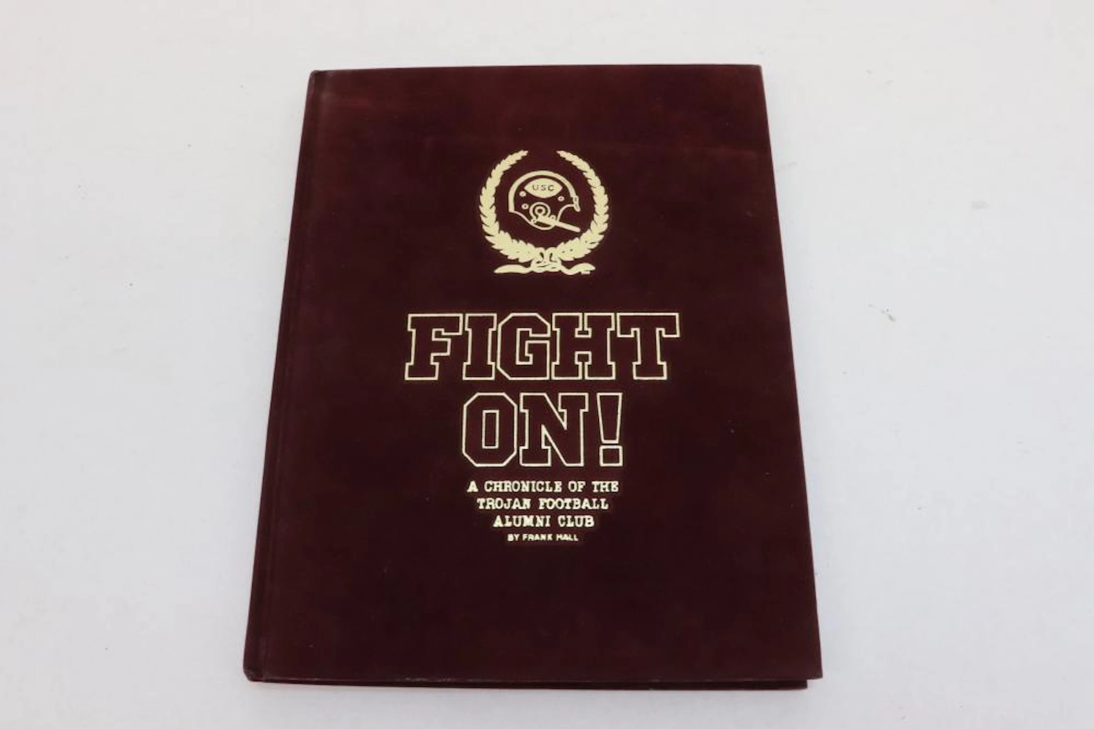"fight on, Trojan football alumni club" signed by former players