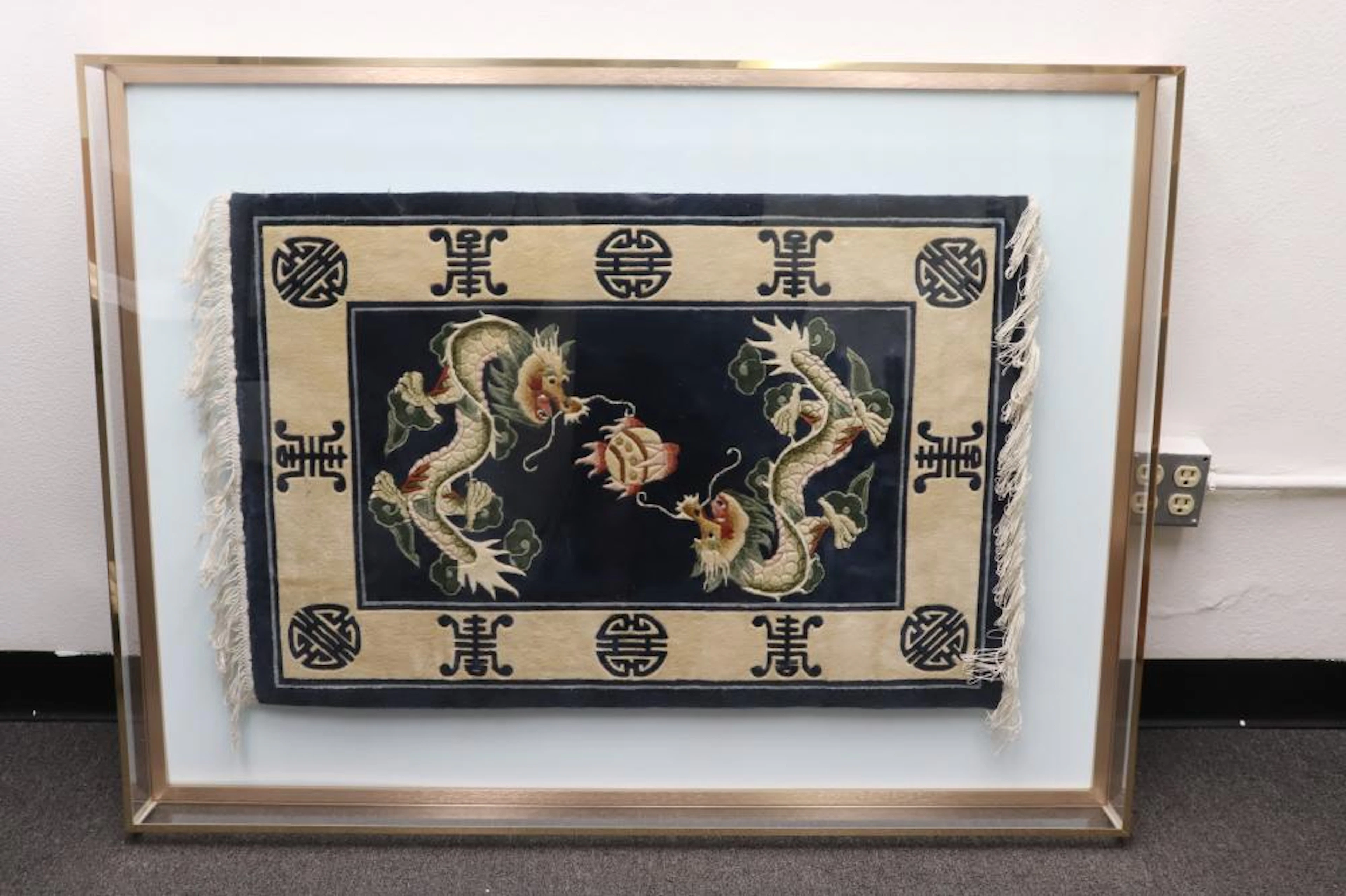 Chinese dragon carpet in Lucite display case