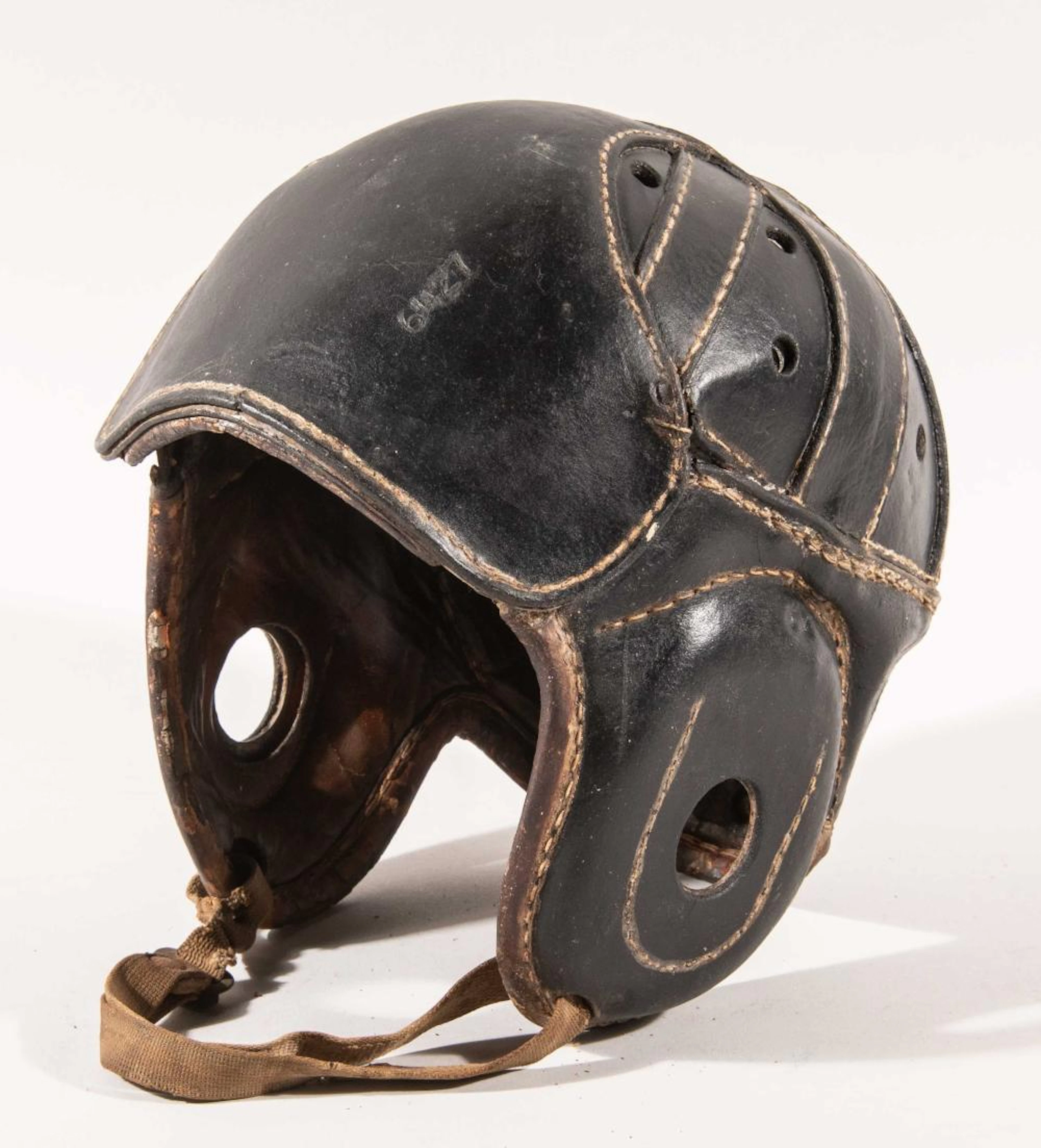 Unusual black leather football helmet with turtle shell...