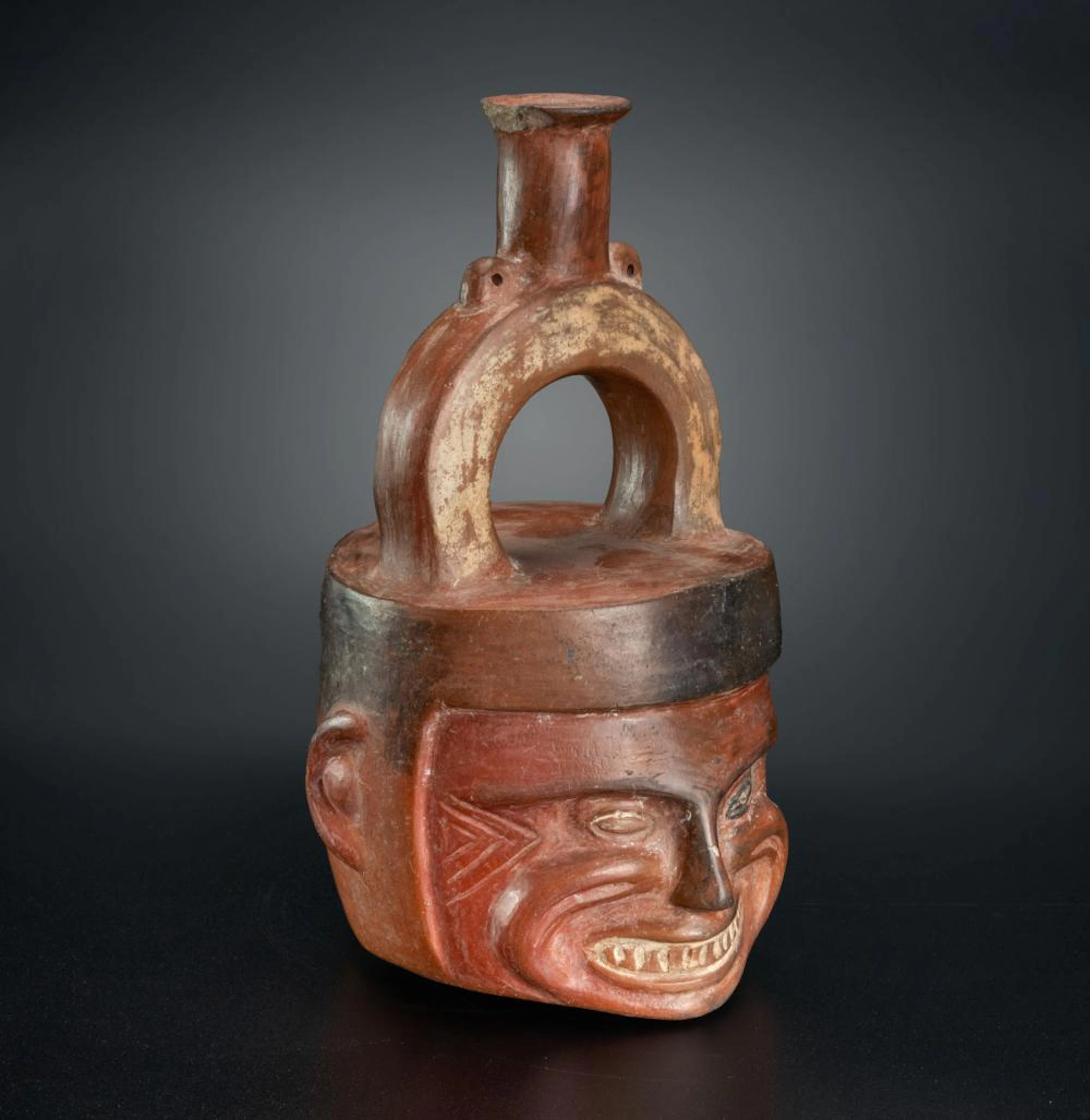 A Stirrup-Spout Effigy Bottle: Grimacing Face, Chimu Inca, Peru, 1470-1534 CE