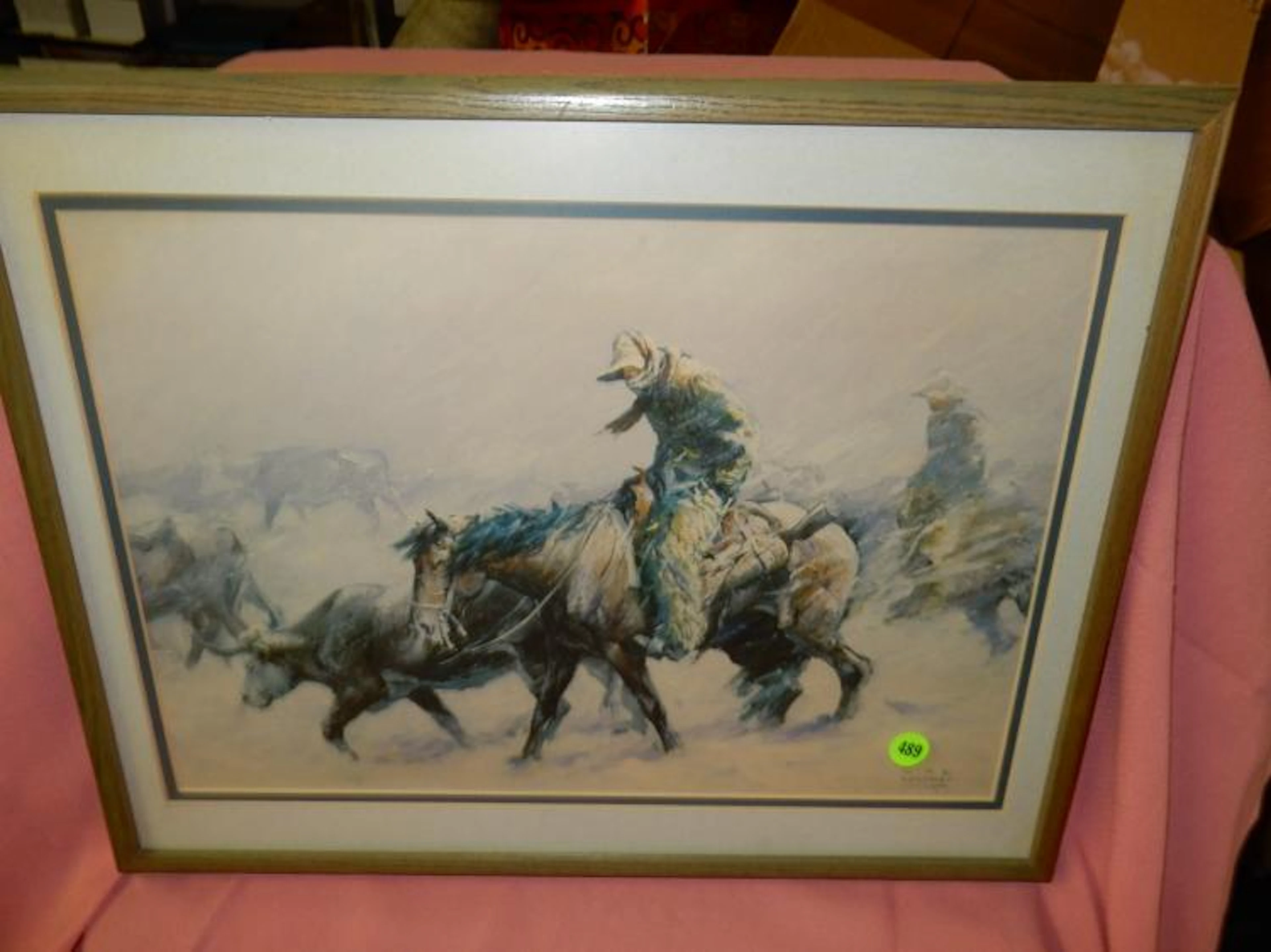 Framed western print depicting cowboy in winet with cattle