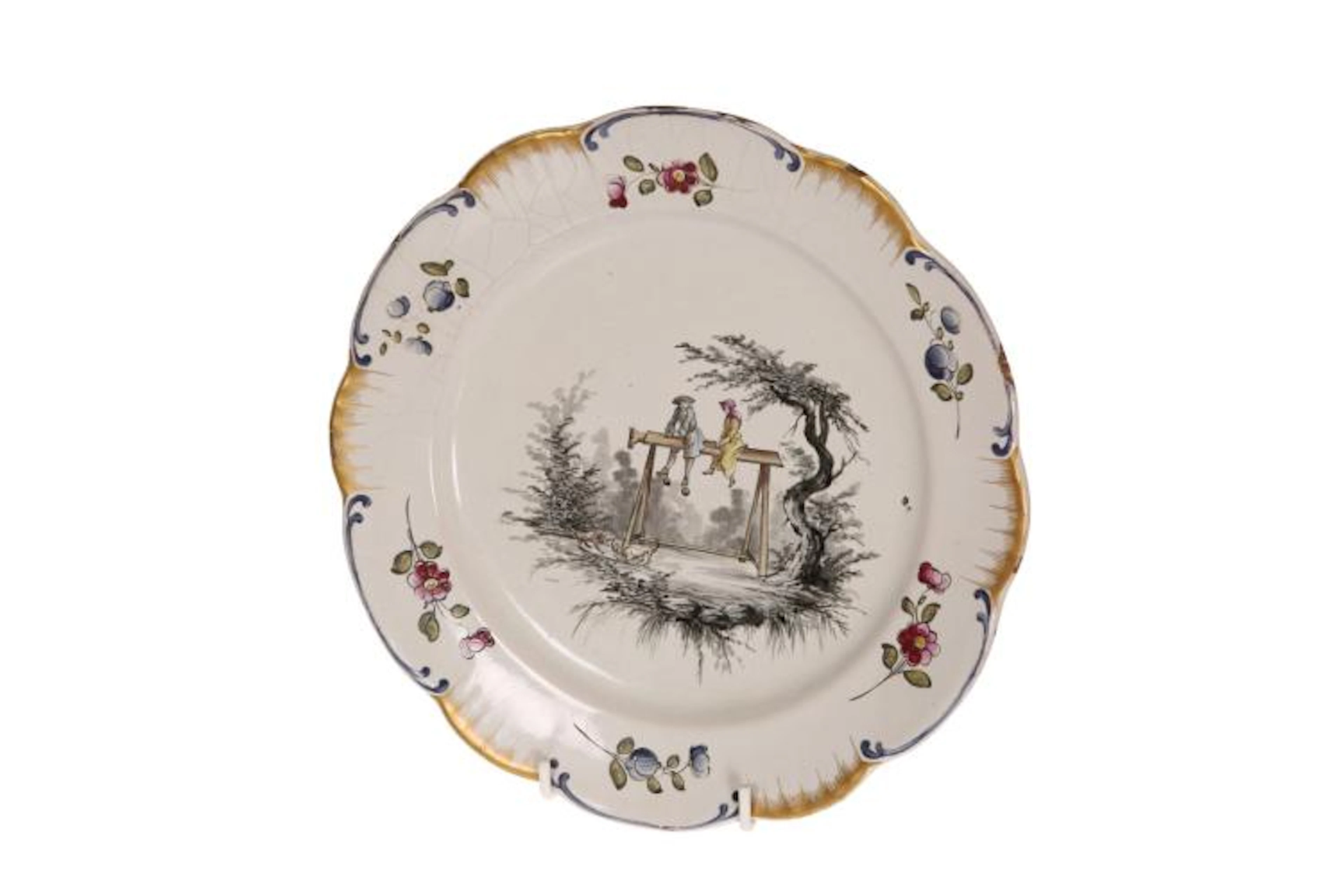 A HÖCHST TIN-GLAZED PLATE, with scallop edge, painted with an interesting s