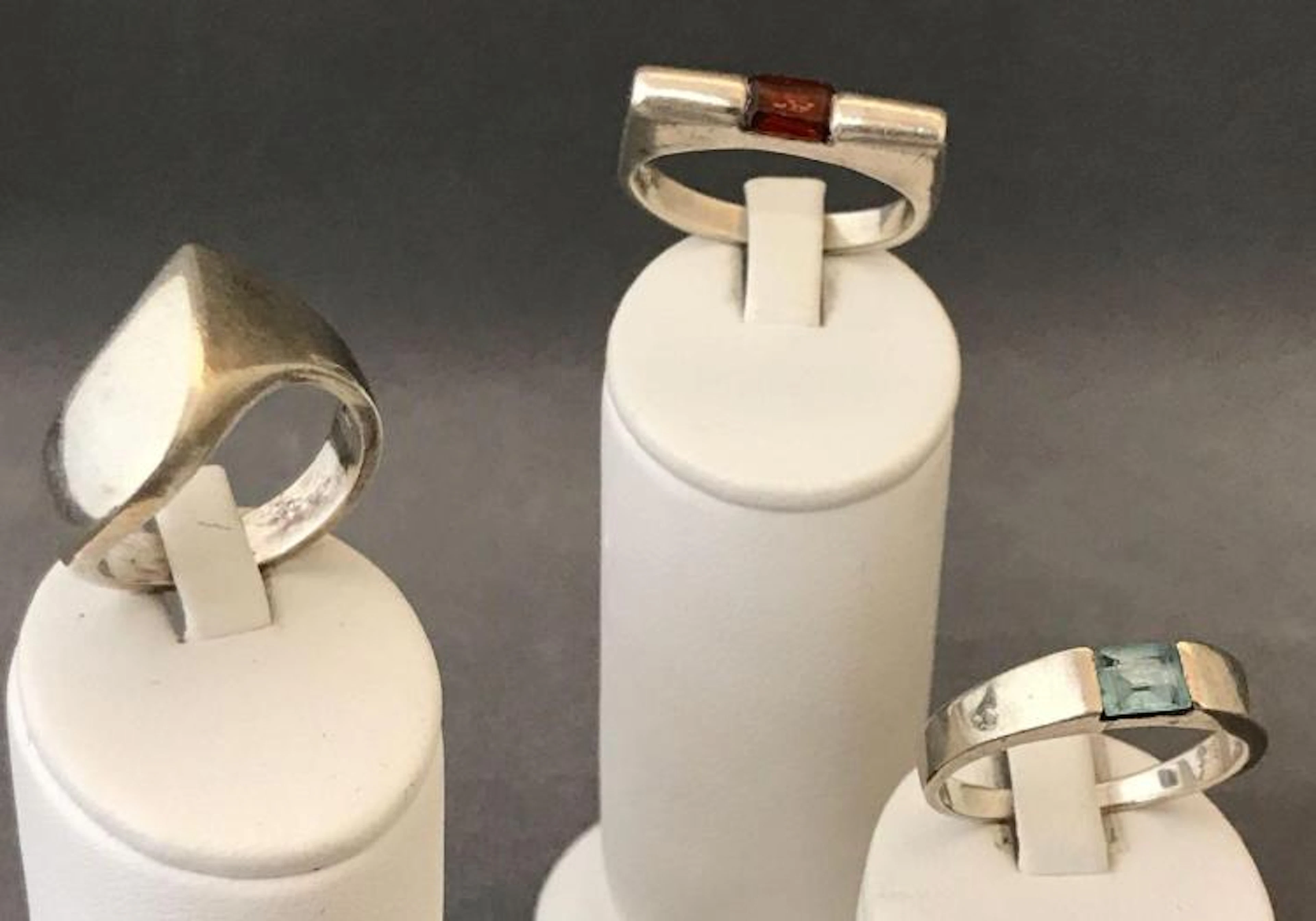 Three Modernist sterling silver rings one with Garnet one with blue topaz.