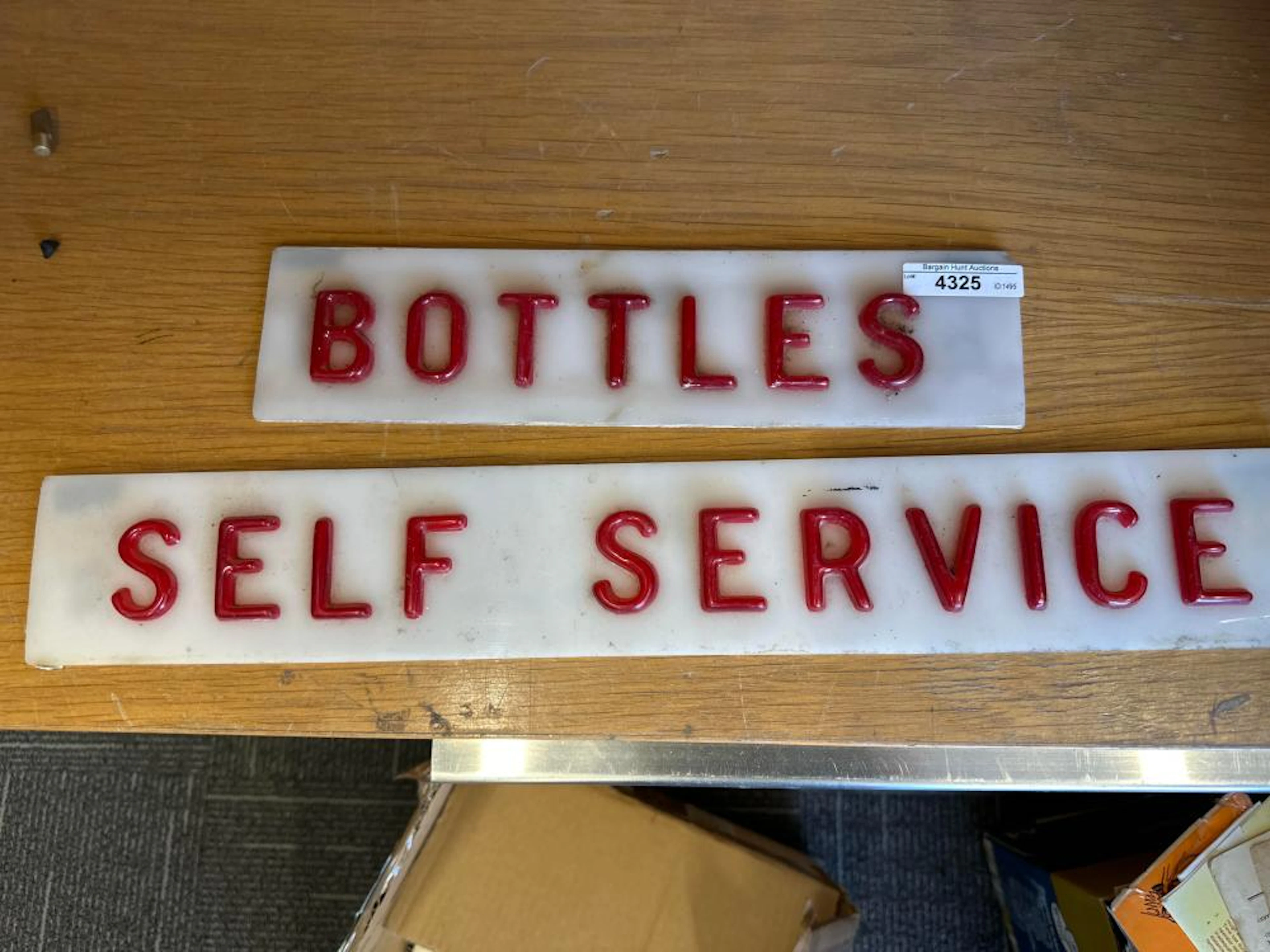 Vintage bottles self service signs, in acrylic. Largest is 46cm L, 7cm H.