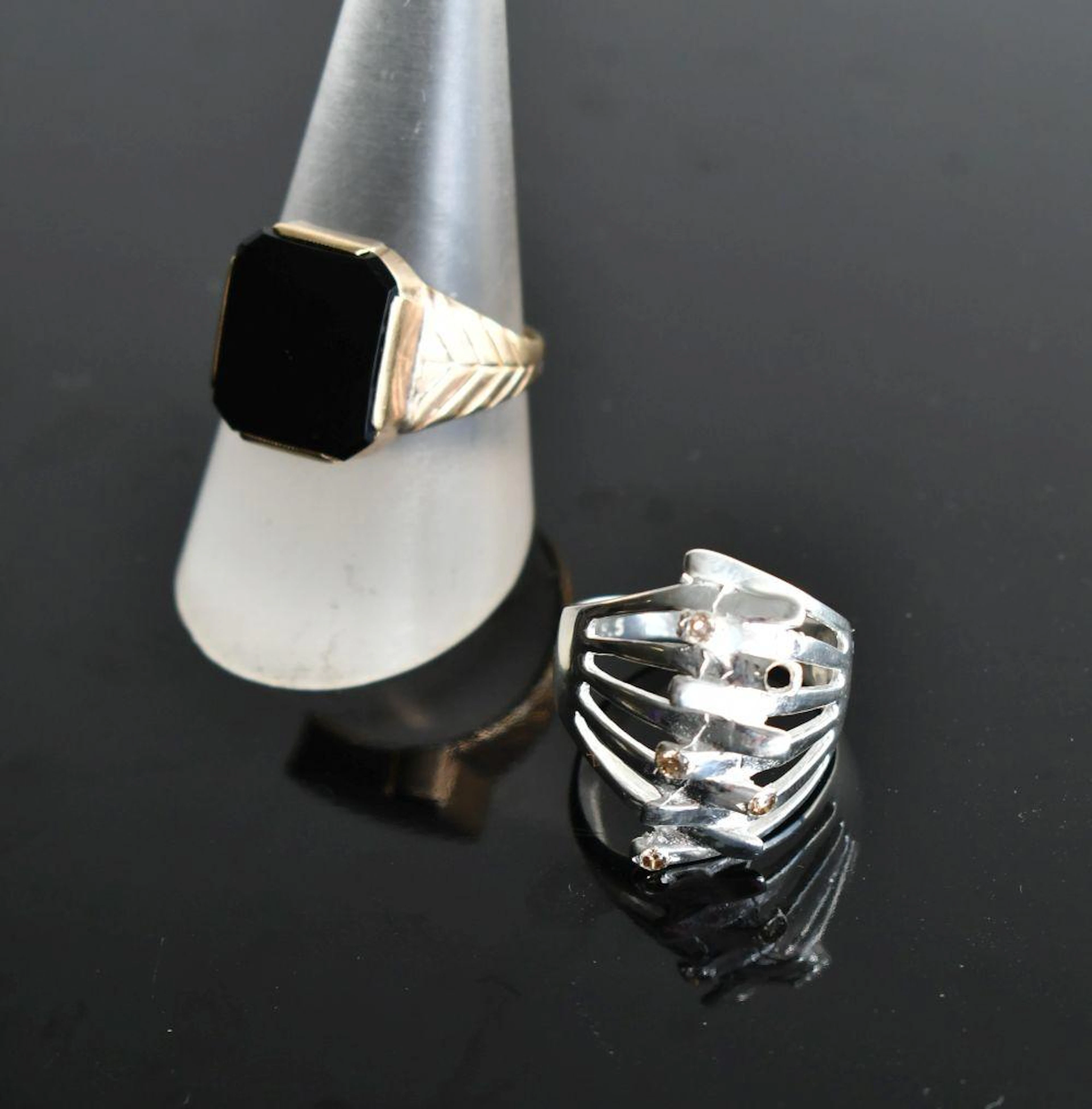 two various rings, including diamond set, Diamond ring size M, onyx ring size T.