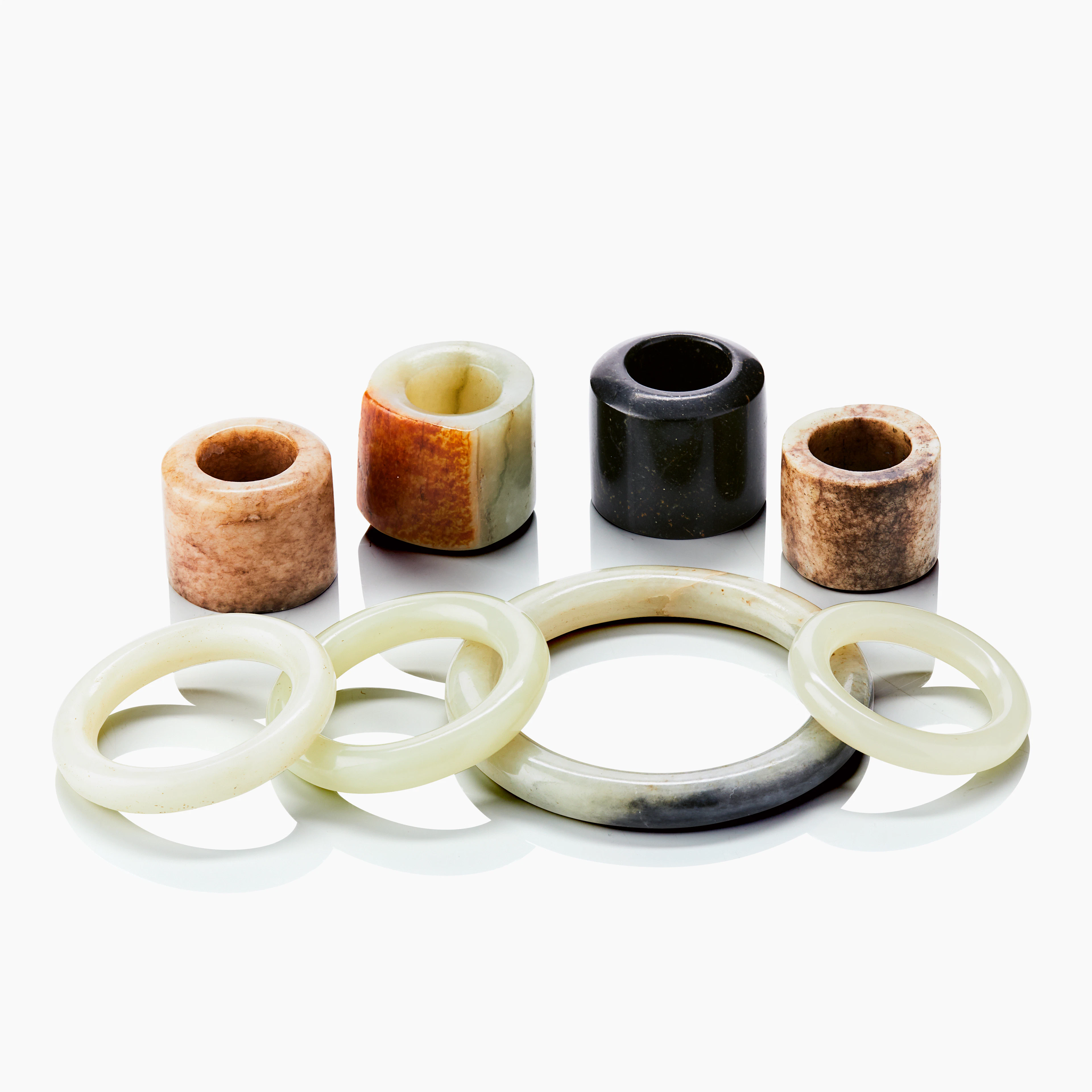 A Group of Four Predominantly Nephrite Jade Rings and Four Bangles