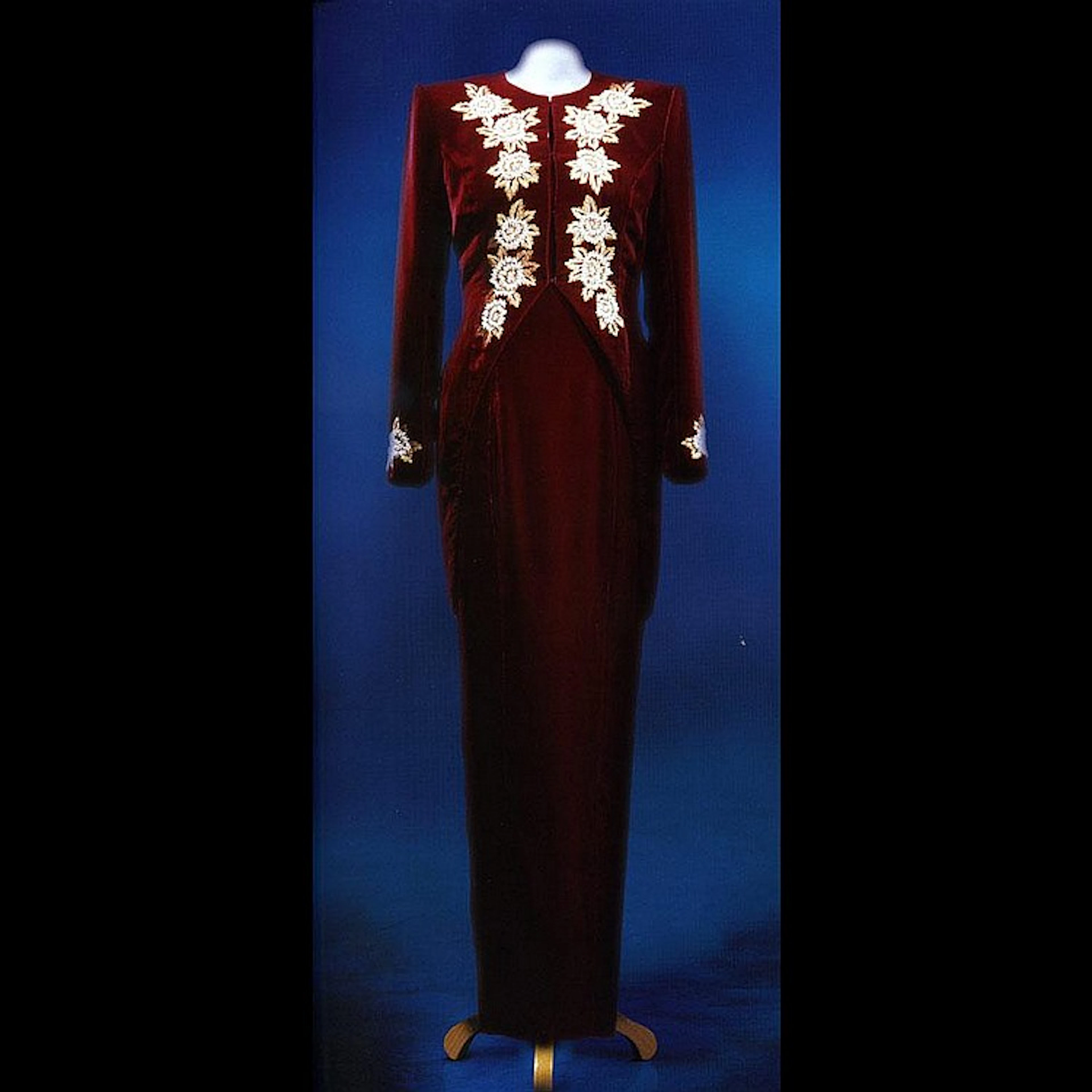 A long dinner dress and tailcoat of burgundy velvet