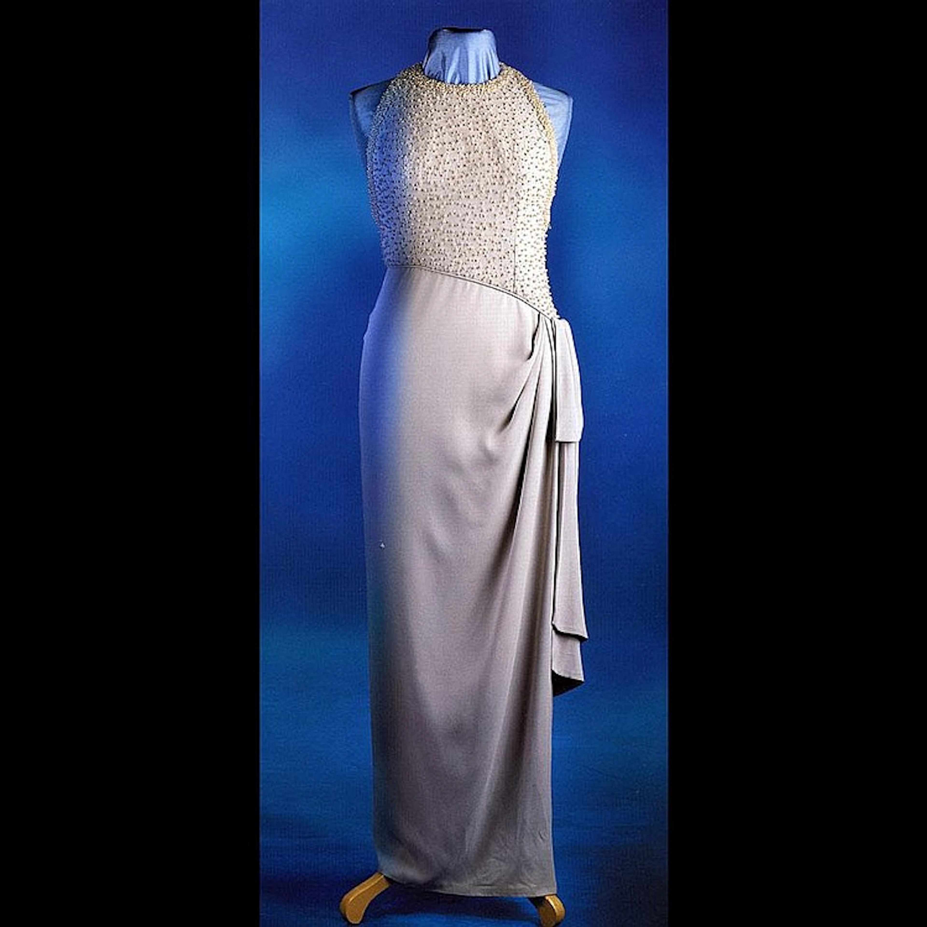 A chic, sarong inspired, evening dress of grey silk crepe