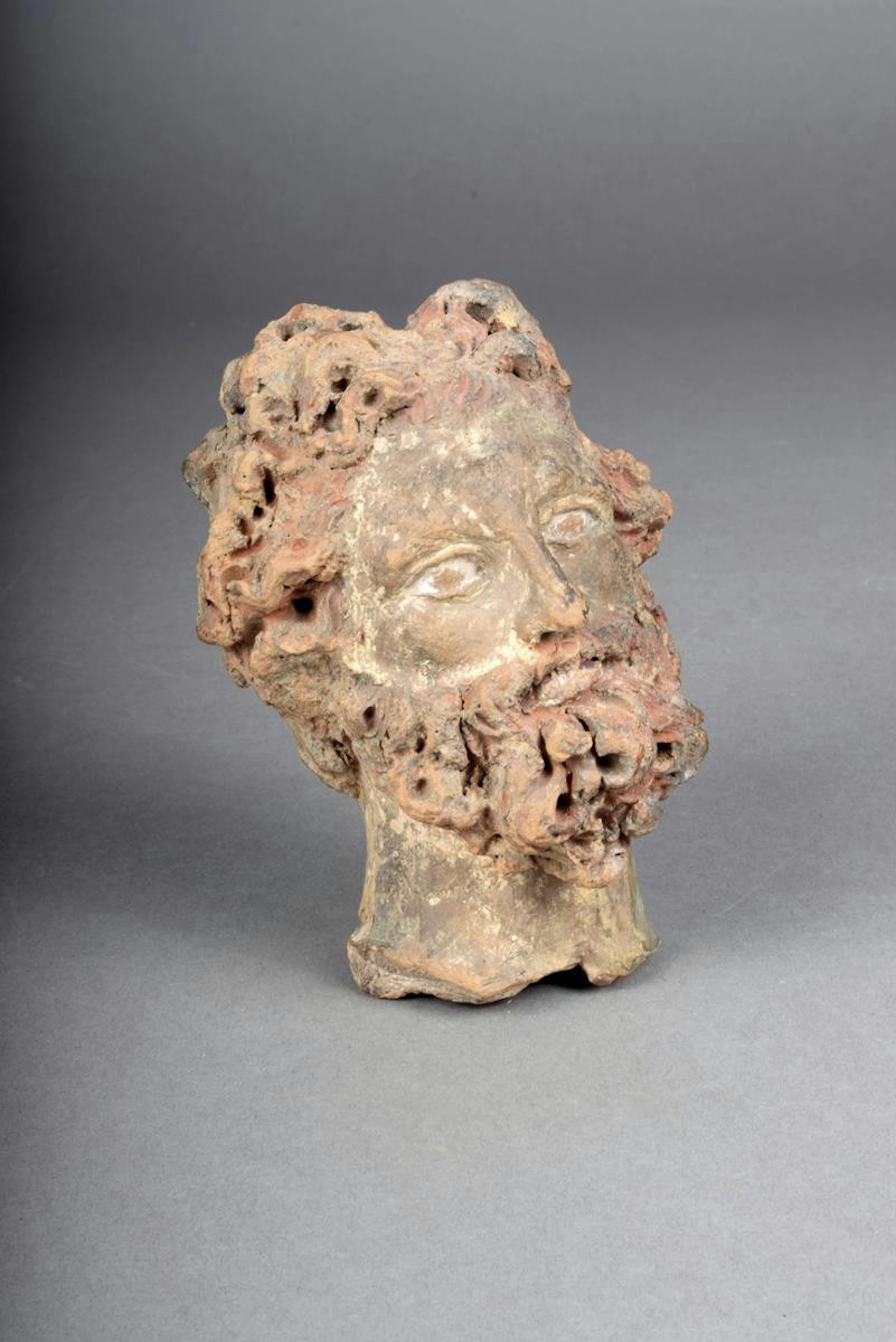 A Greek terracotta male head