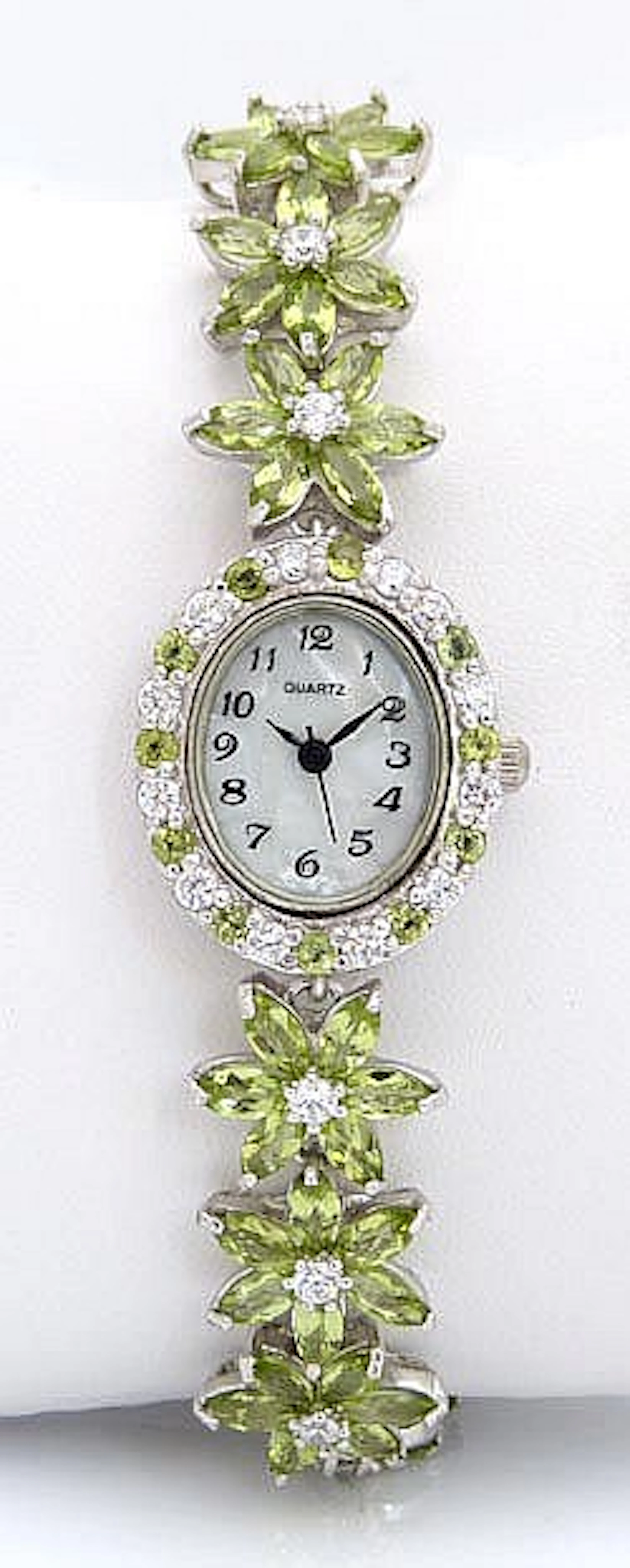 A SILVER, ZIRCON AND PERIDOT WRISTWATCH, BY QUARTZ